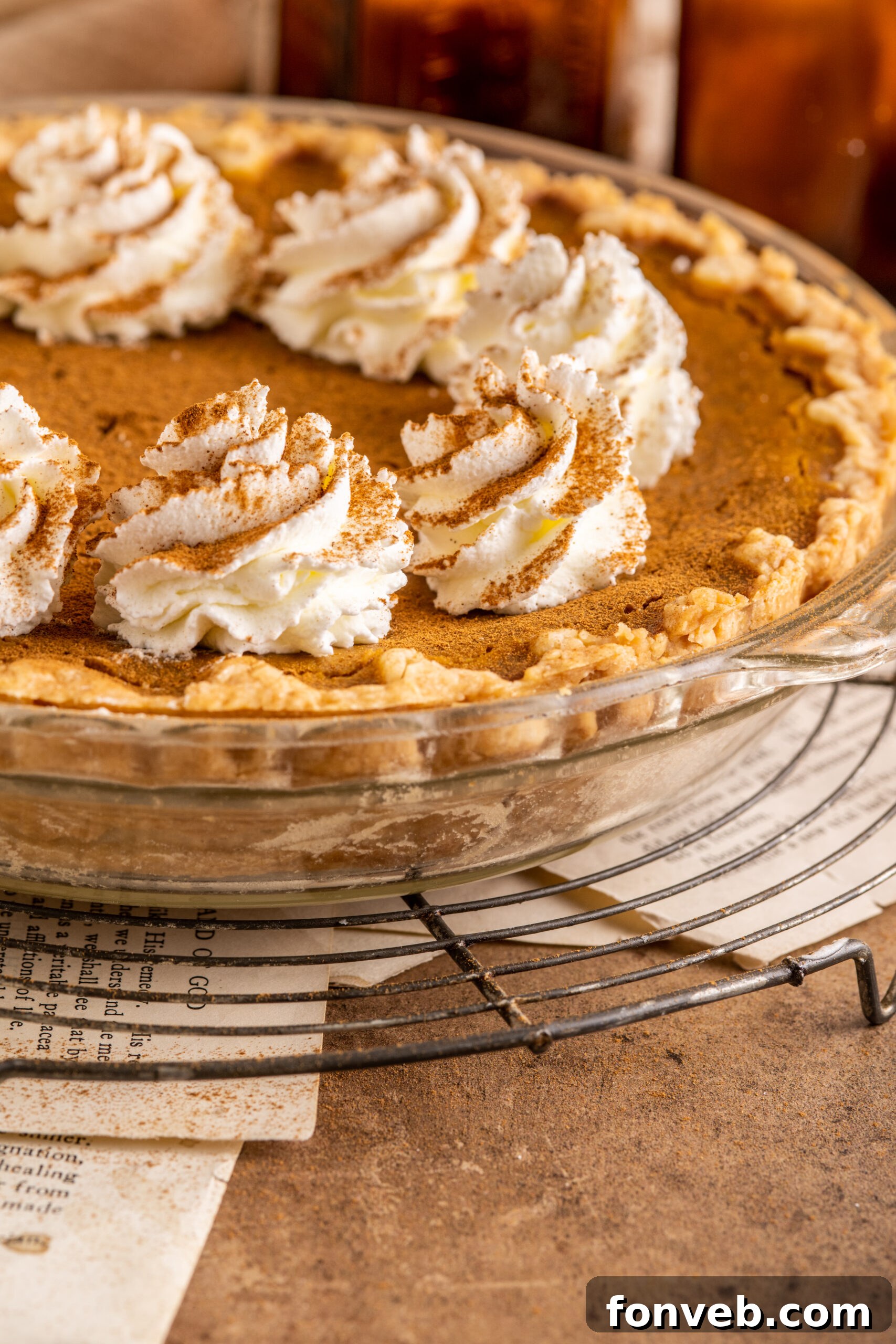 Velvet Pumpkin Dream Pie 7 A pristine, uncut Pumpkin Custard Pie showcasing its smooth, perfectly set surface in a clear glass pie dish.