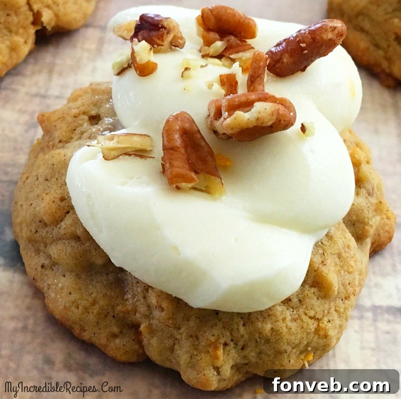 Delicious carrot cake cookies topped with orange cream cheese frosting