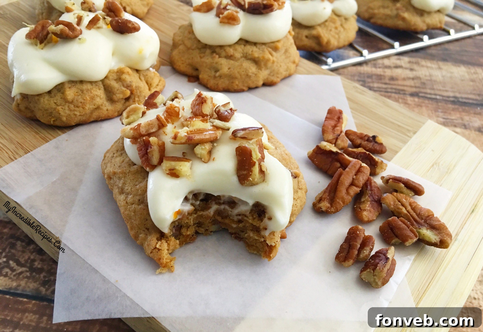 A plate of several frosted carrot cake cookies, showcasing their perfect texture
