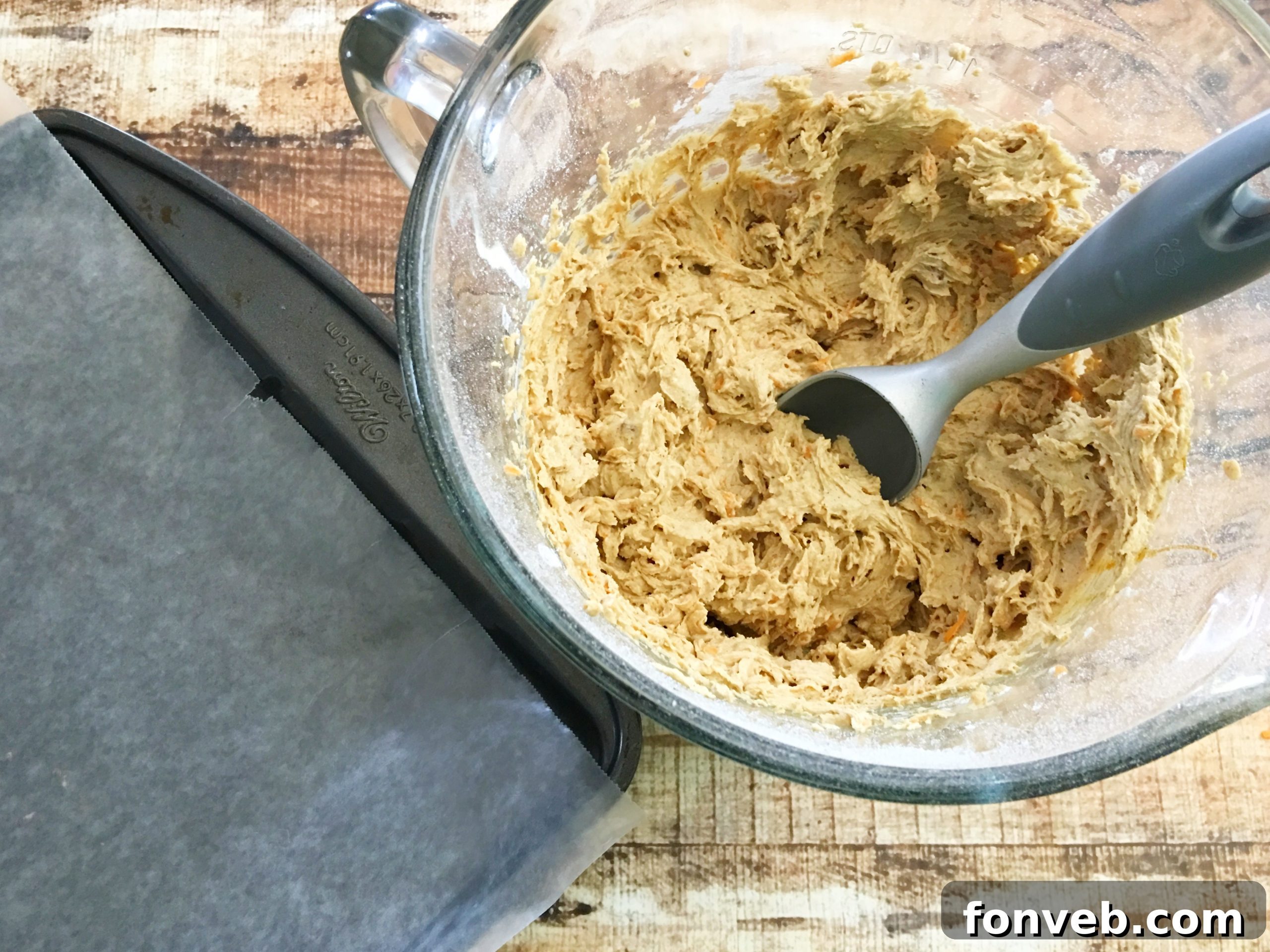 Close-up of a carrot cake cookie batter with chopped pecans