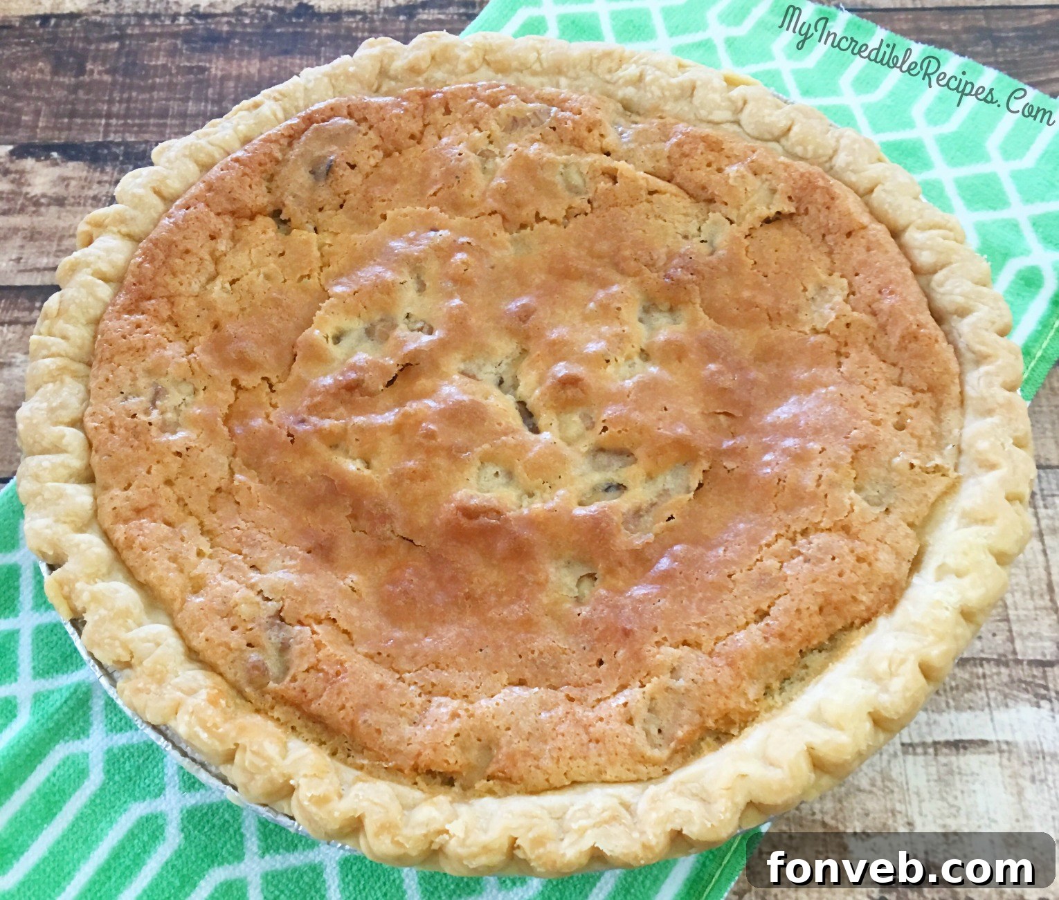 Warm chocolate chip pie slice topped with melting vanilla ice cream