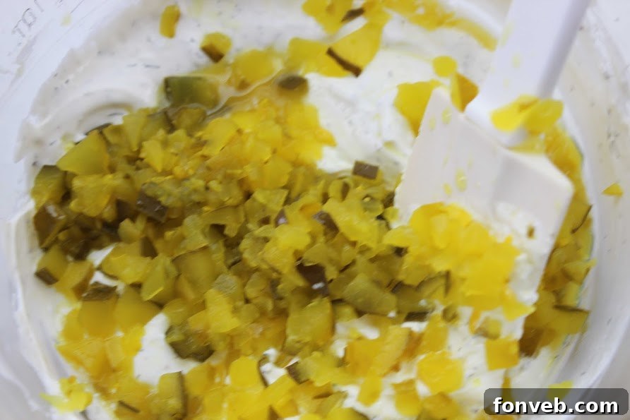 A tub of high-quality sour cream and a block of cream cheese, essential creamy bases for the Dill Pickle Dip.