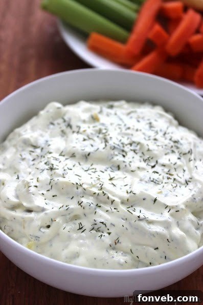 Finely sliced dill pickles, ready to be incorporated into the creamy dip mixture.