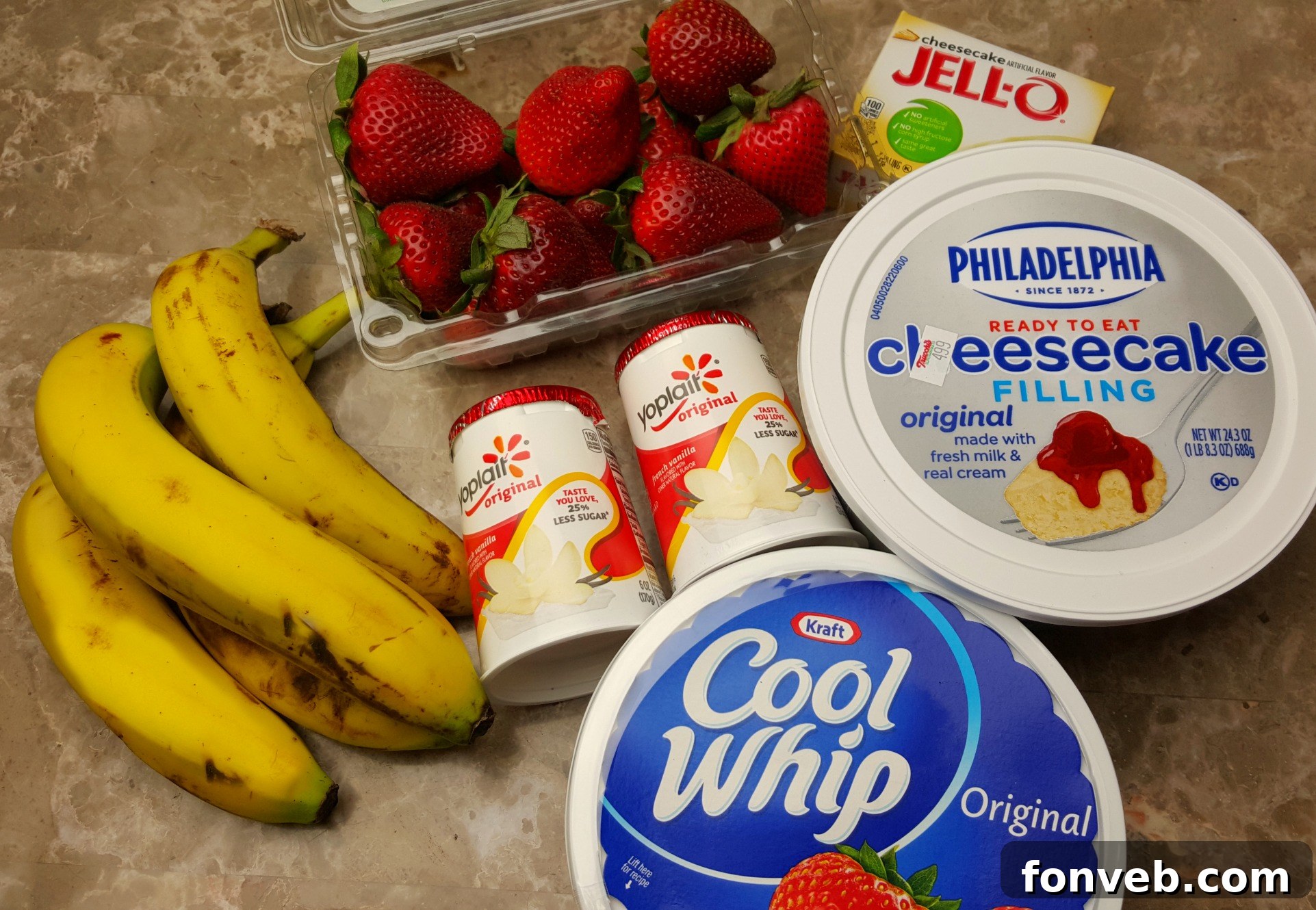 Strawberry Banana Cheesecake Delight 3 Ingredients laid out for a delicious Strawberry Banana Cheesecake Salad, including fresh strawberries, ripe bananas, and creamy filling components.