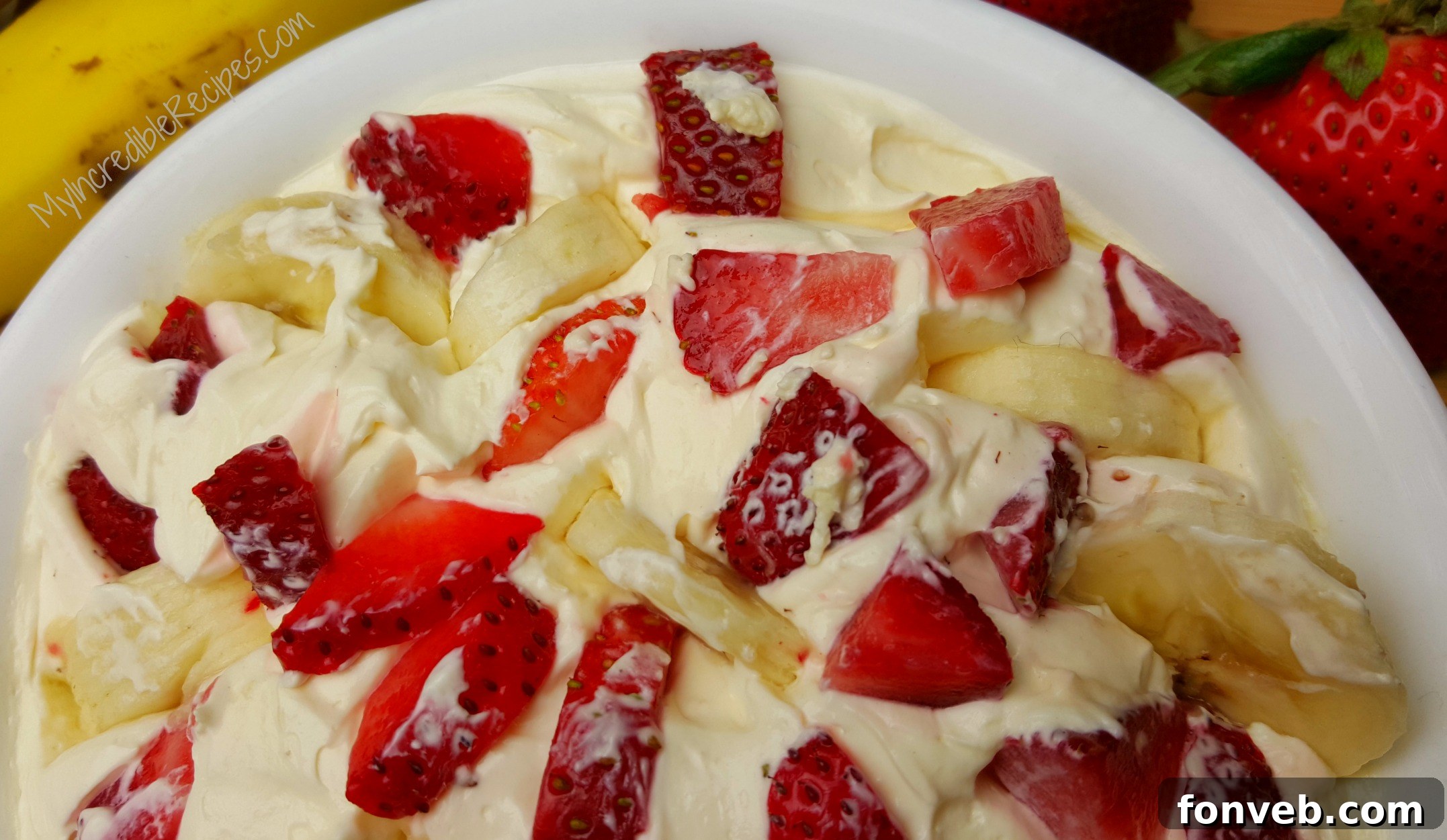 Strawberry Banana Cheesecake Delight 4 Close-up of a creamy Strawberry Banana Cheesecake Salad, showcasing the smooth texture and delicious fruit.