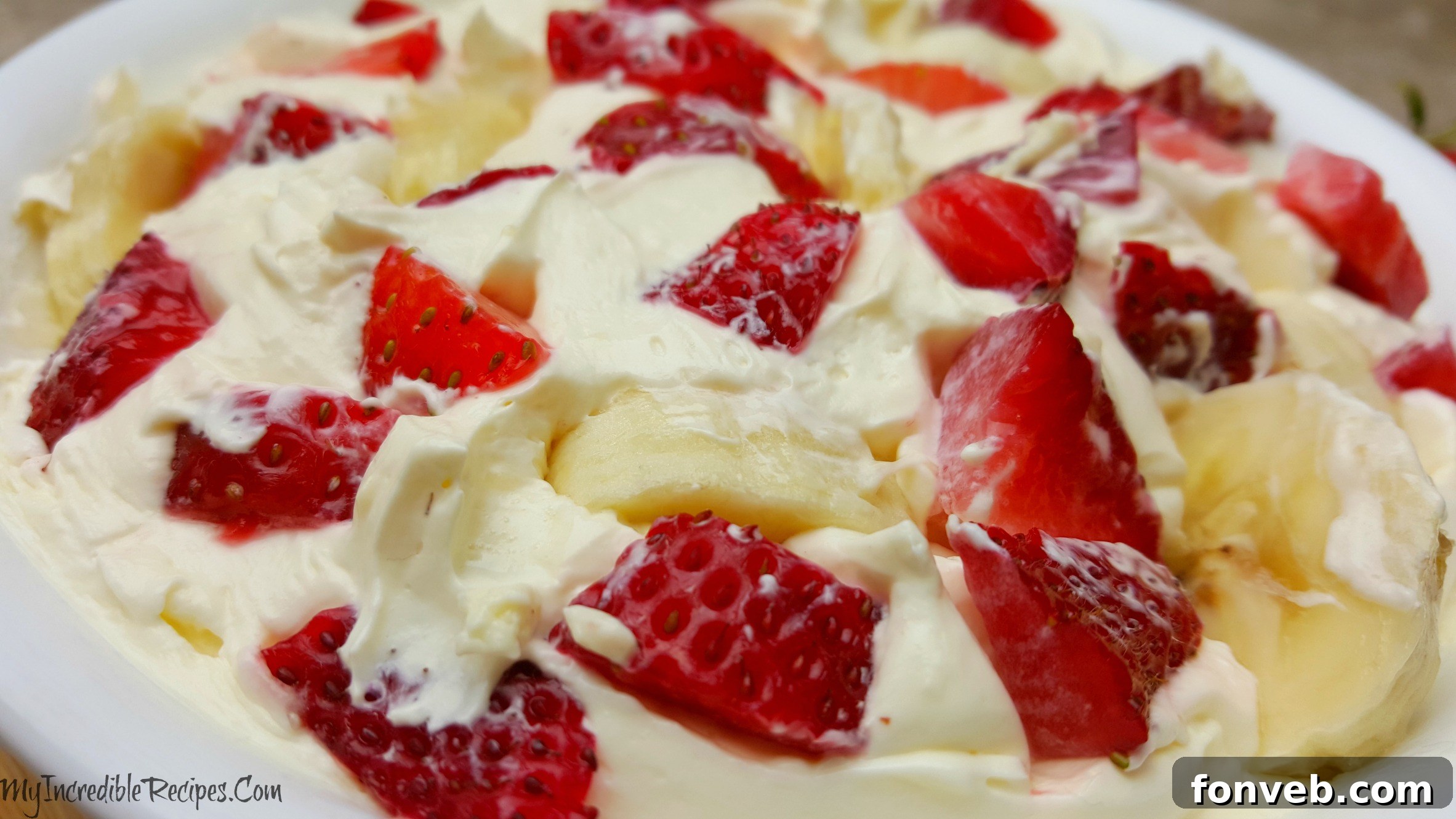 Strawberry Banana Cheesecake Delight 5 A large serving of Strawberry Banana Cheesecake Salad, perfect for sharing at a family gathering or party.