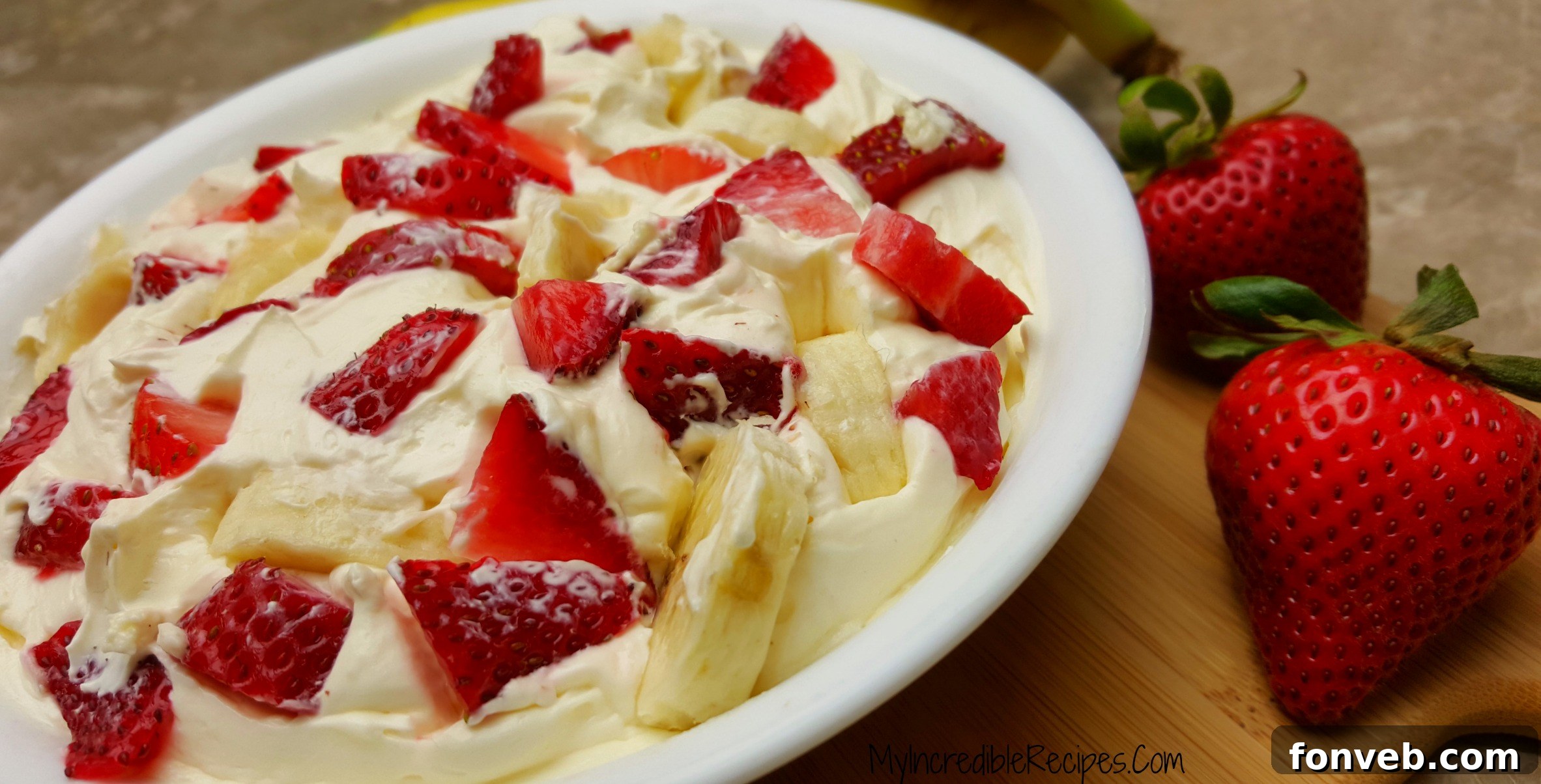 Strawberry Banana Cheesecake Delight 7 A generous scoop of Strawberry Banana Cheesecake Salad, showcasing its irresistible creamy texture and fresh fruit.