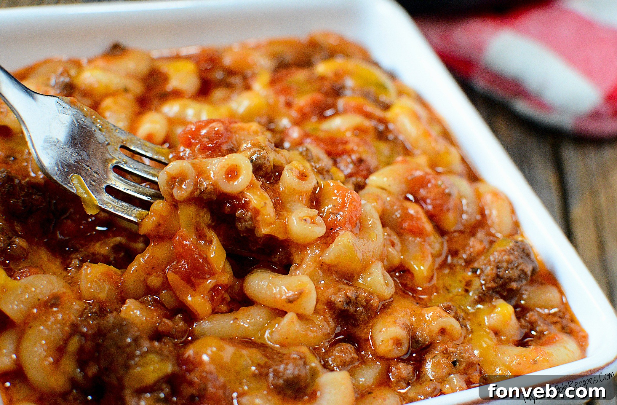 A close-up of Old Fashioned Goulash in a large white bowl, showcasing the rich sauce and tender noodles.