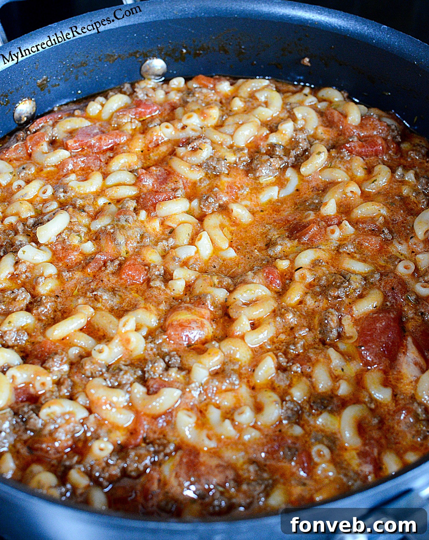 An overhead shot of Old Fashioned Goulash bubbling in a pot, showcasing its rich texture and ingredients.