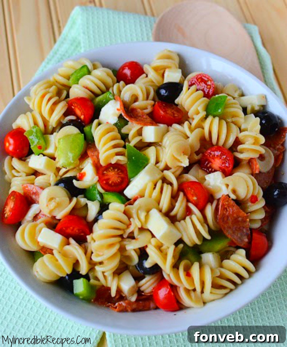 A child happily enjoying a plate of Italian Pizza Pasta Salad, highlighting its kid-friendly appeal and deliciousness