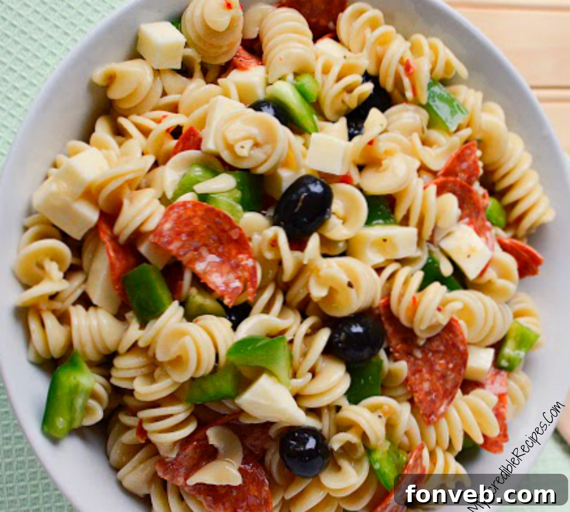 The finished Italian Pizza Pasta Salad, beautifully garnished with Parmesan cheese, ready to be served to guests