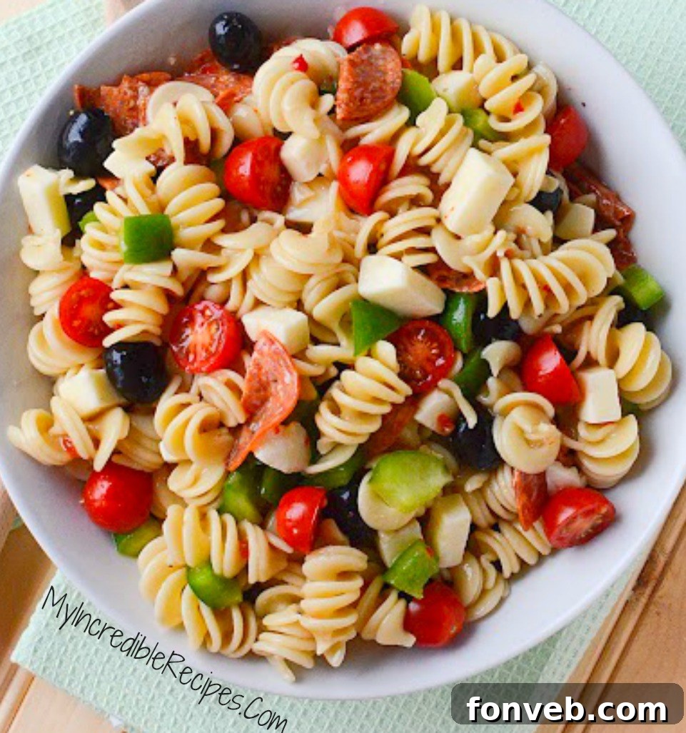 Another perspective of the Italian Pizza Pasta Salad, highlighting the different textures and colors of the ingredients after mixing