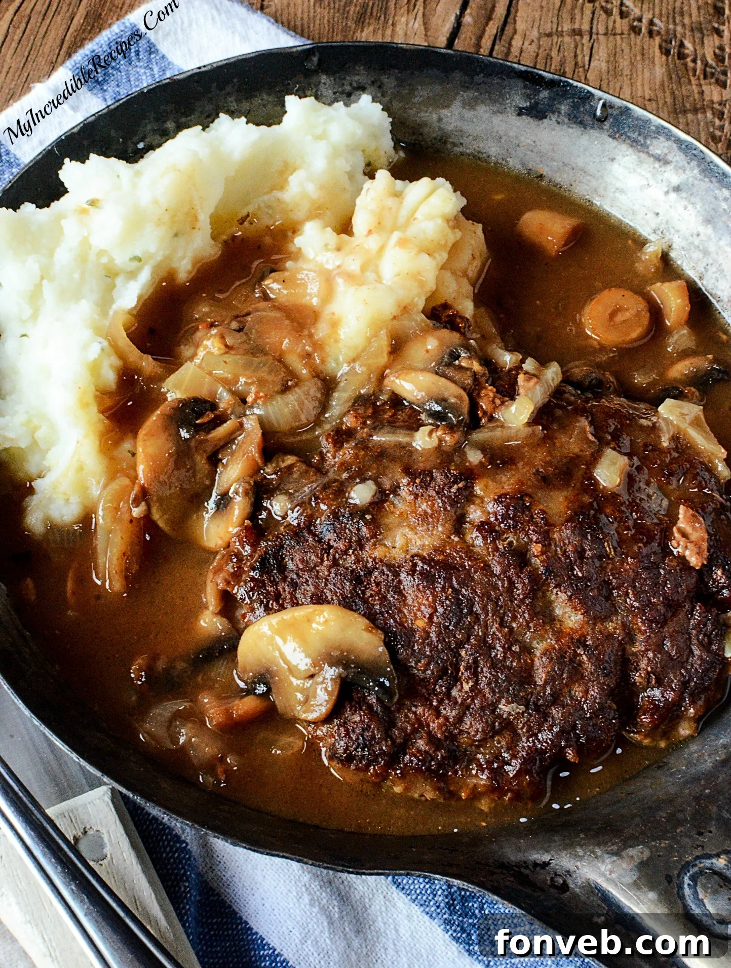 Southern Hamburger Steaks served over a bed of mashed potatoes, smothered in gravy.