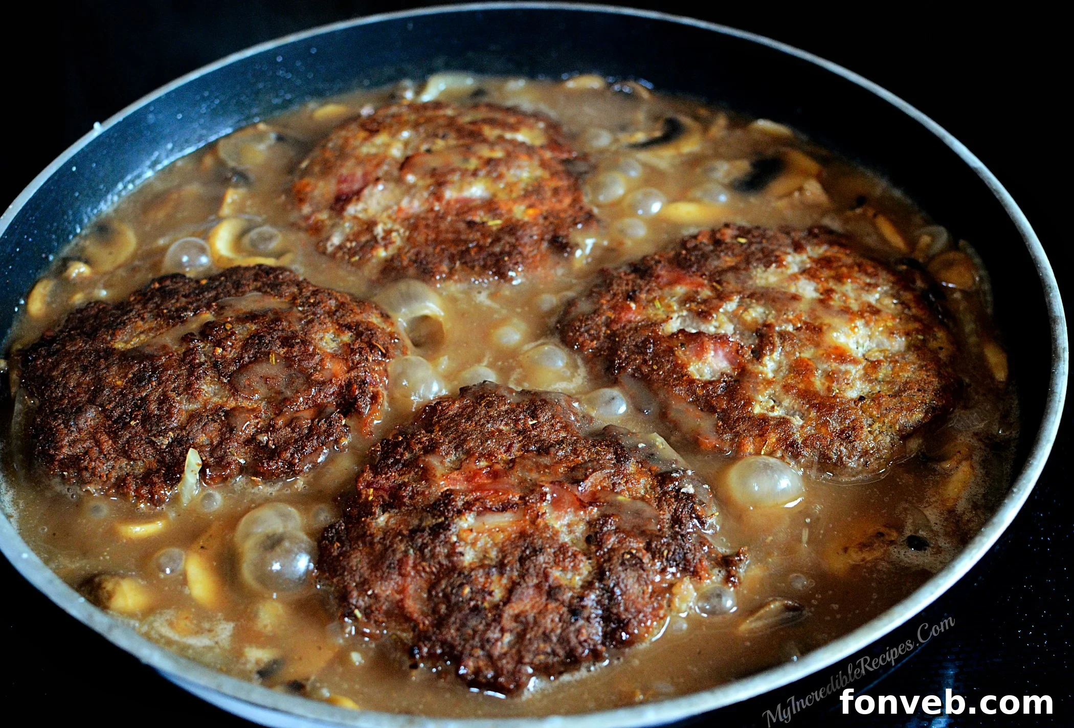Golden-brown hamburger steaks resting after searing, ready for the gravy.