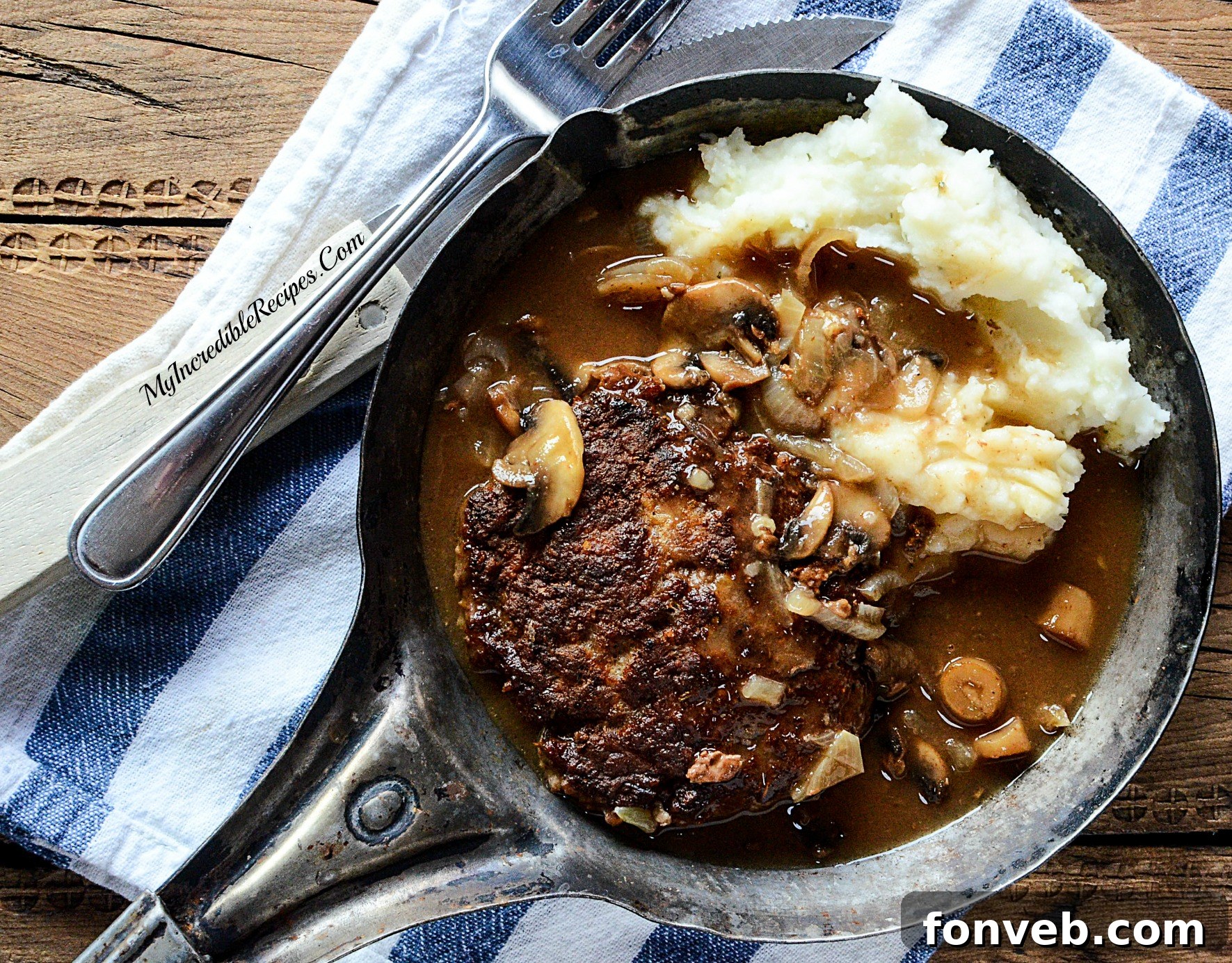 Hamburger steak covered in thick onion mushroom gravy, simmering to perfection.