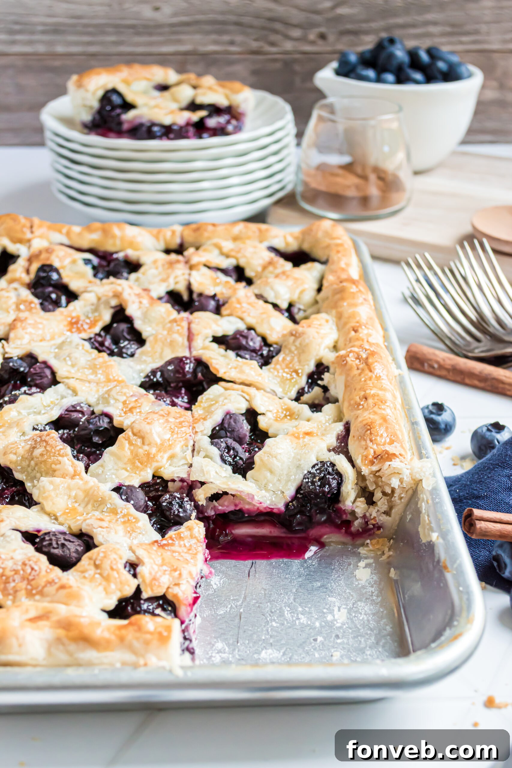 The golden-brown Blueberry Slab Pie beautifully displayed in a silver baking pan, ready to be served.