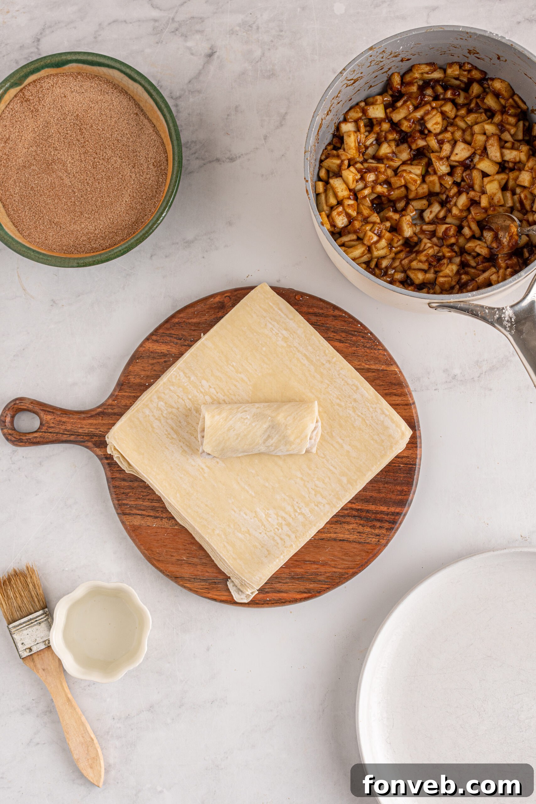 Overhead view of the wrapped apple pie egg roll. 