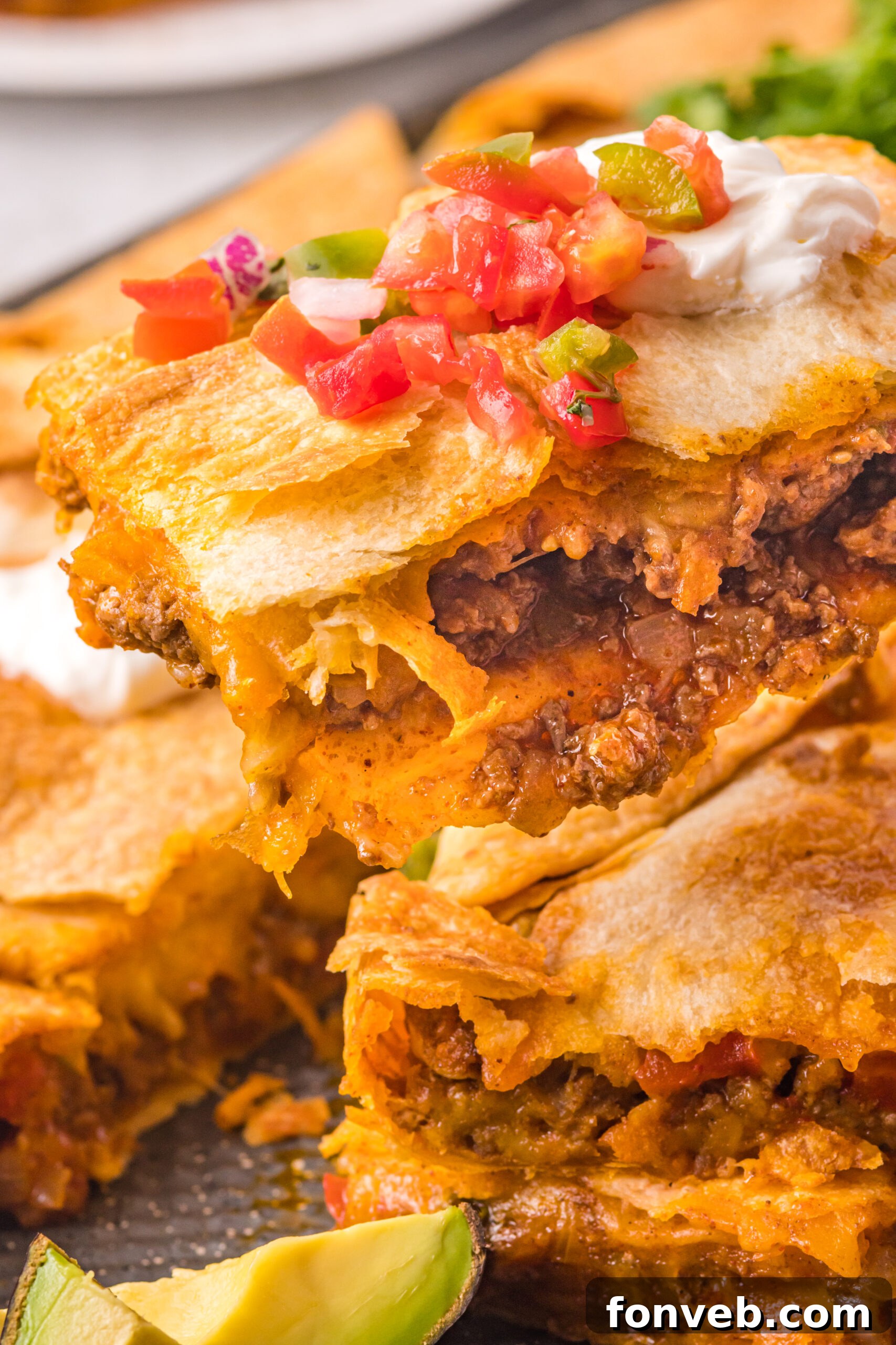 One Pan Baked Tacos 11 A piece of golden-brown sheet pan taco being carefully lifted and removed from the baking sheet, showcasing its perfect form and readiness to be topped