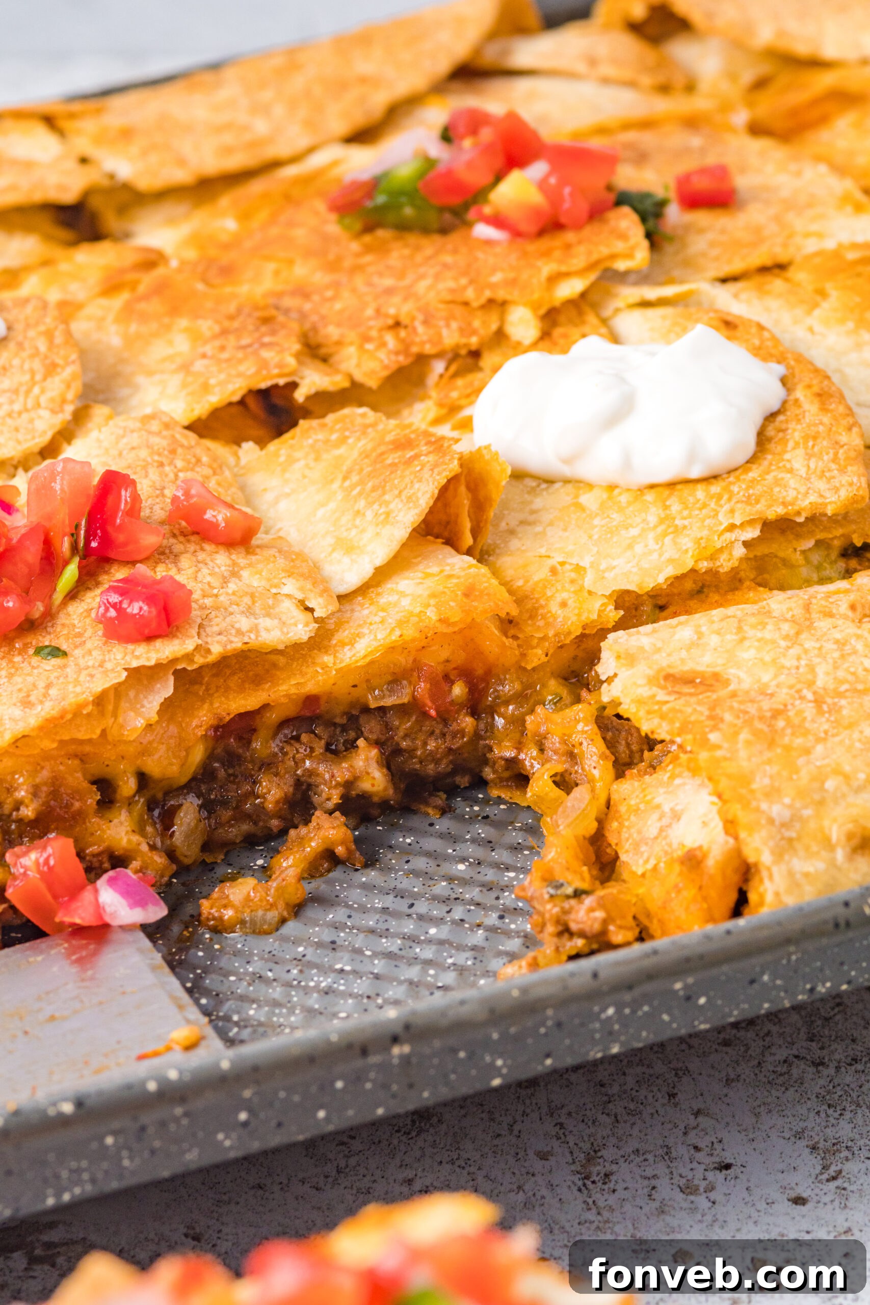One Pan Baked Tacos 12 A perfect cross-section shot revealing the luscious layers of seasoned ground beef, melted cheese, and tender tortillas inside the sheet pan tacos