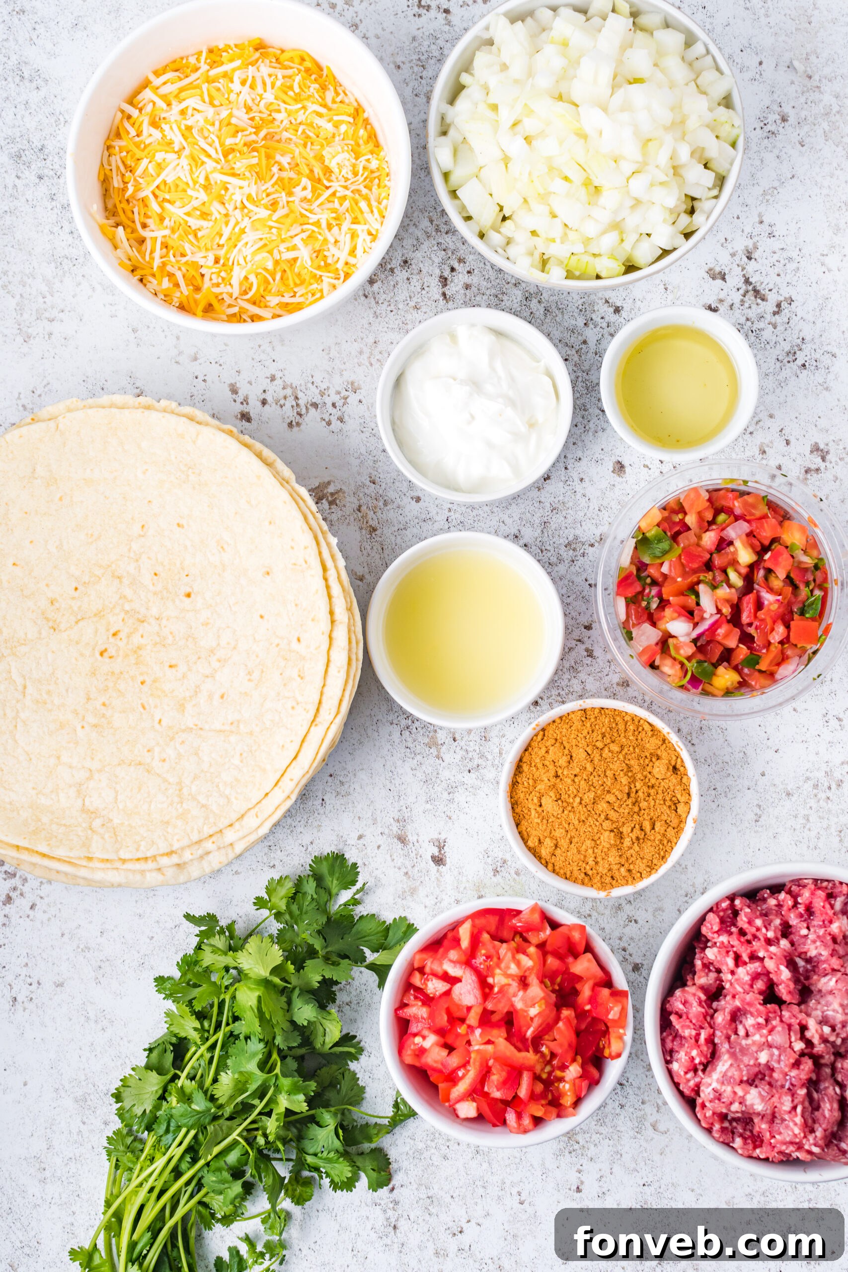 One Pan Baked Tacos 5 Overhead shot showcasing all the fresh and essential ingredients neatly laid out for preparing the sheet pan tacos, including ground beef, tortillas, cheese, and fresh produce