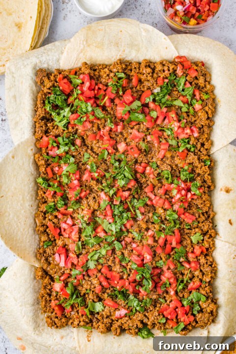 One Pan Baked Tacos 7 A close-up shot of the perfectly browned and folded edges of sheet pan tacos, showing the savory filling peeking through