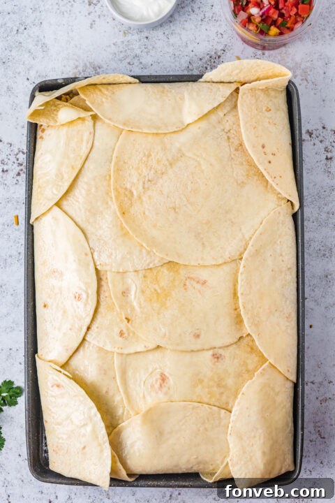 One Pan Baked Tacos 10 A vibrant display of fresh toppings like chopped cilantro, diced tomatoes, and sour cream, perfect for customizing the baked tacos