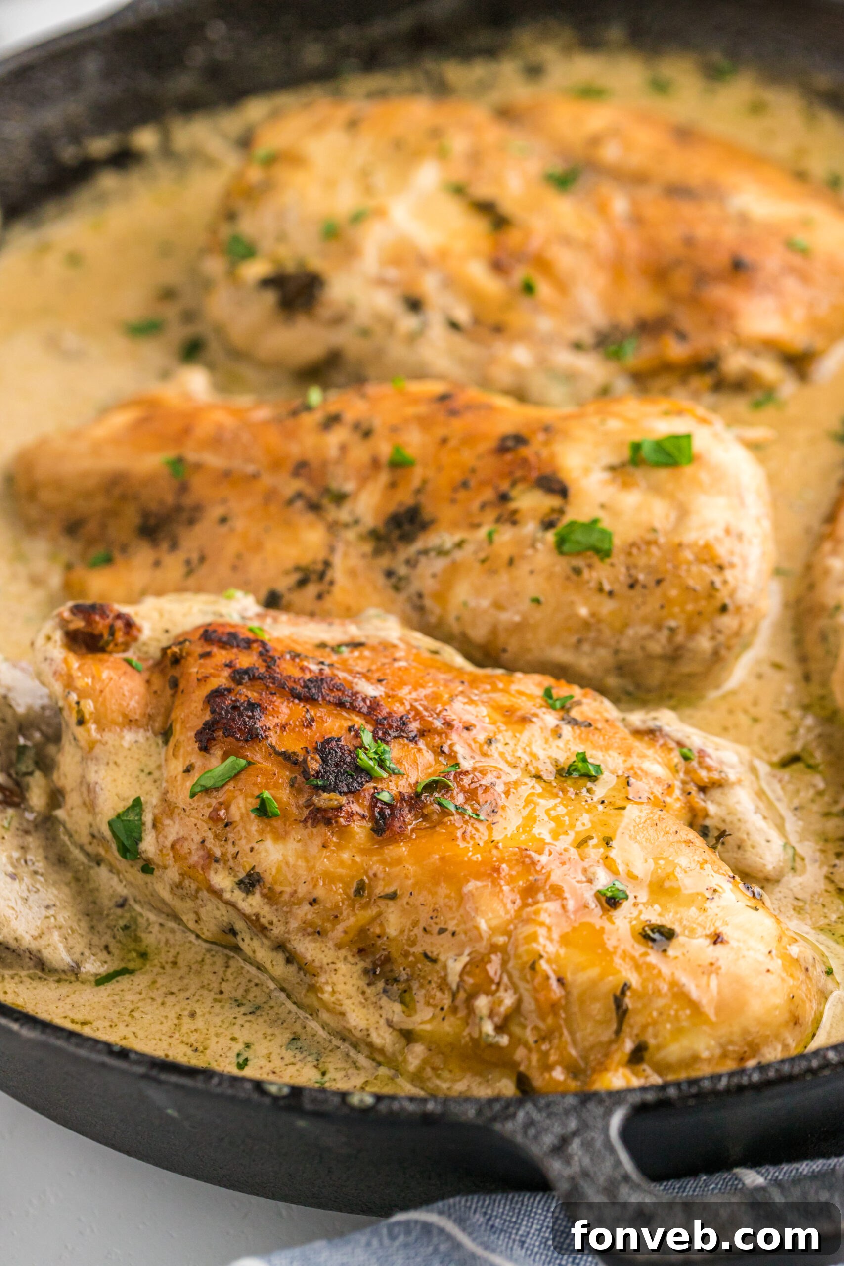 Garlic Butter Chicken Stuffed with Cheesy Mushrooms 2 Cheesy Garlic Butter Mushroom Stuffed Chicken in a cast iron skillet, golden brown and bubbling with sauce.