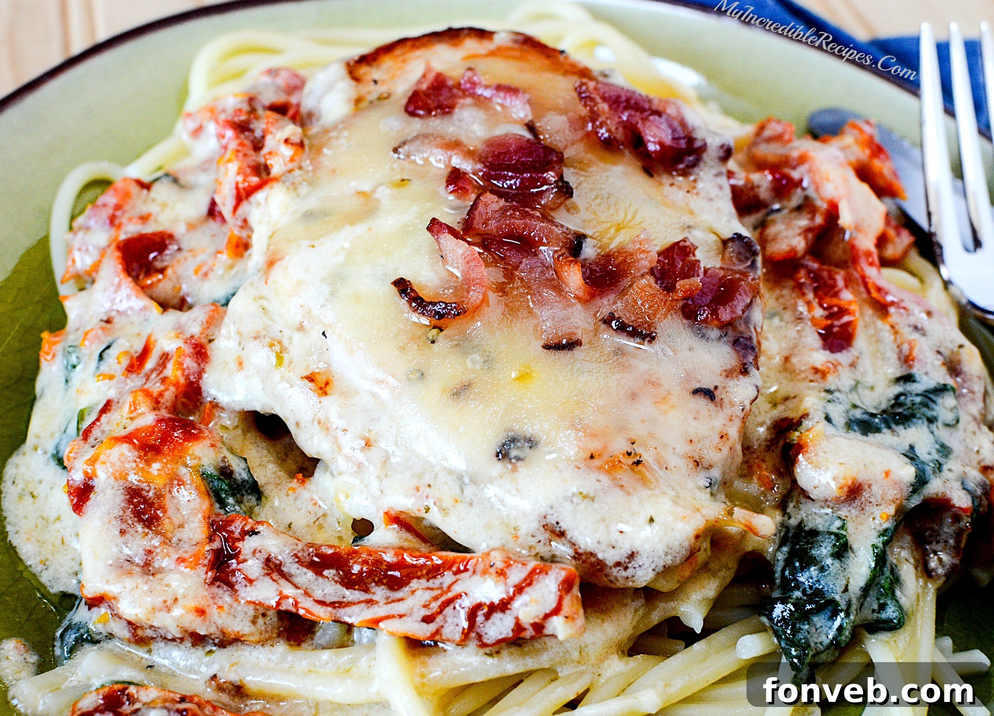 Close-up of creamy chicken served with pasta, showing rich sauce and melted cheese
