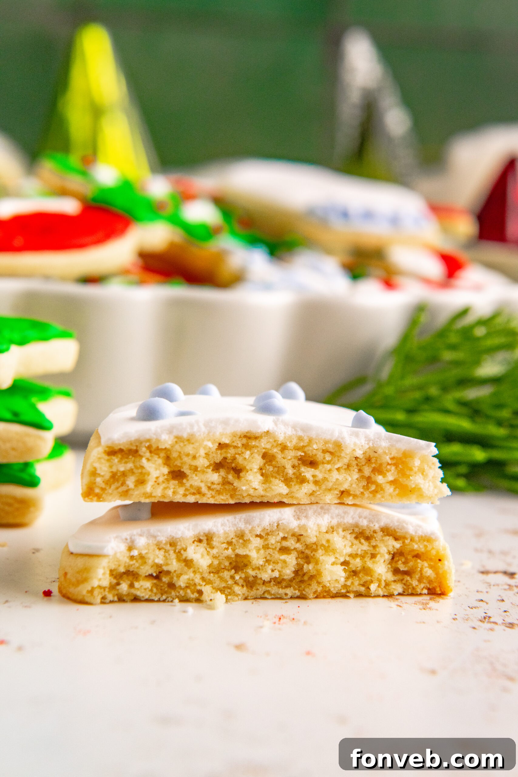 A Christmas Sugar Cookie cut in half showing the chewy inside.