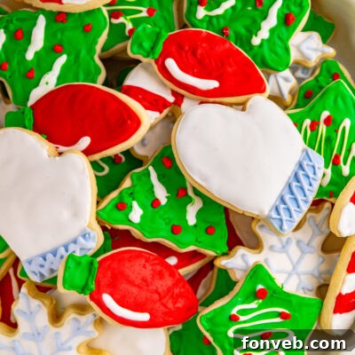 Christmas Sugar Cookies stacked on a white serving tray.