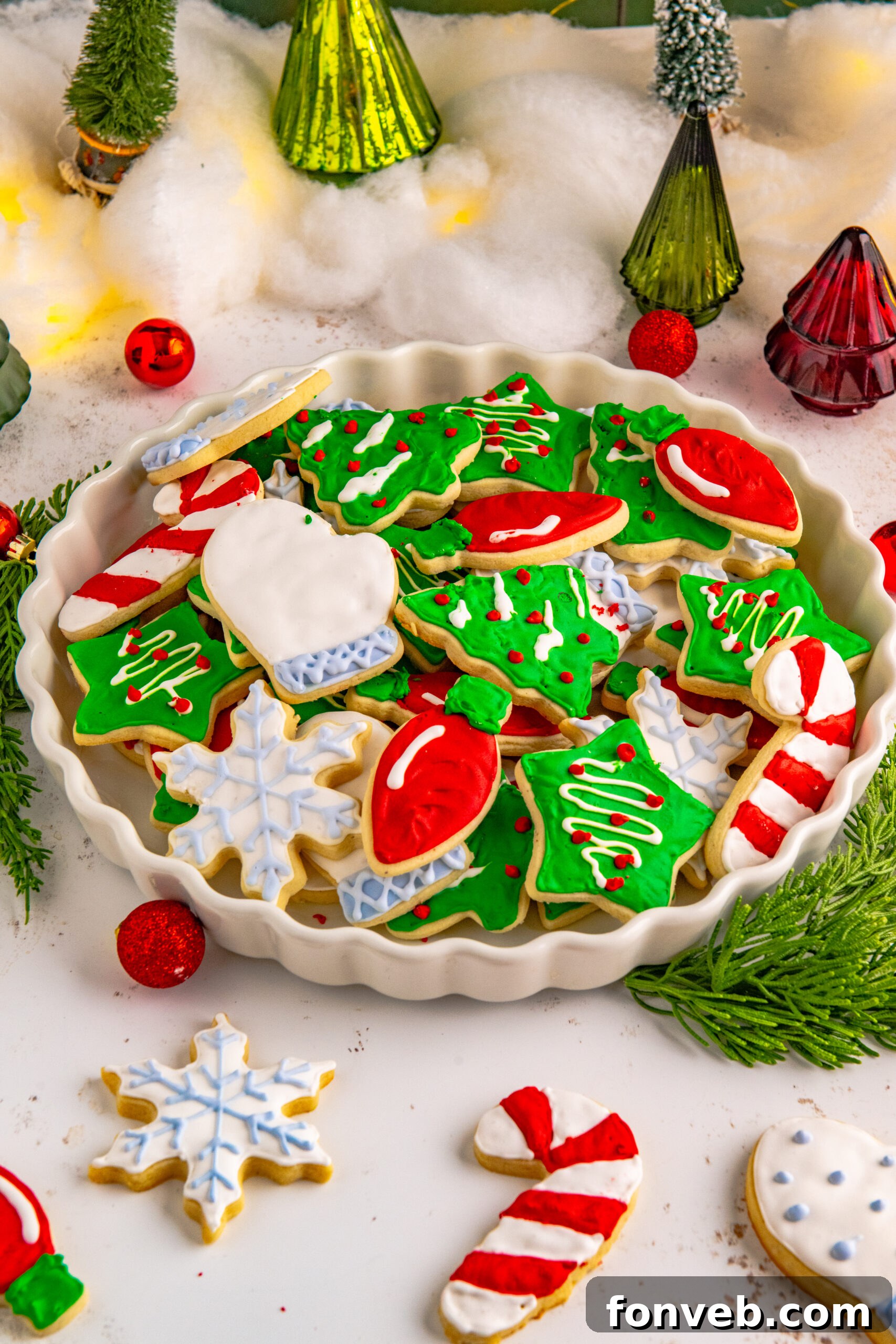 Christmas Sugar Cookies stacked on a white serving tray.