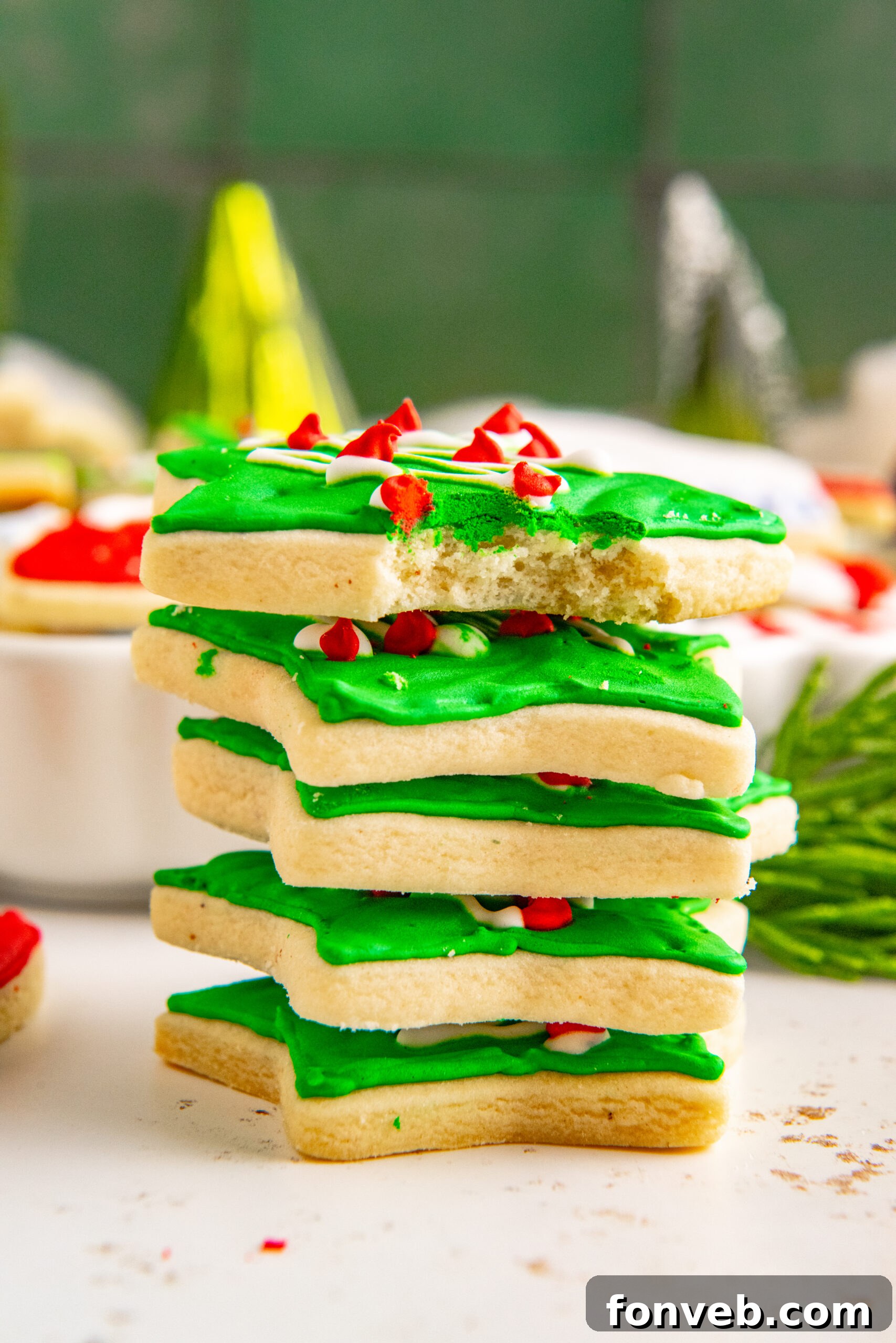 Five Christmas Cookies stacked with a bite removed from the top cookie showing the fluffy center.