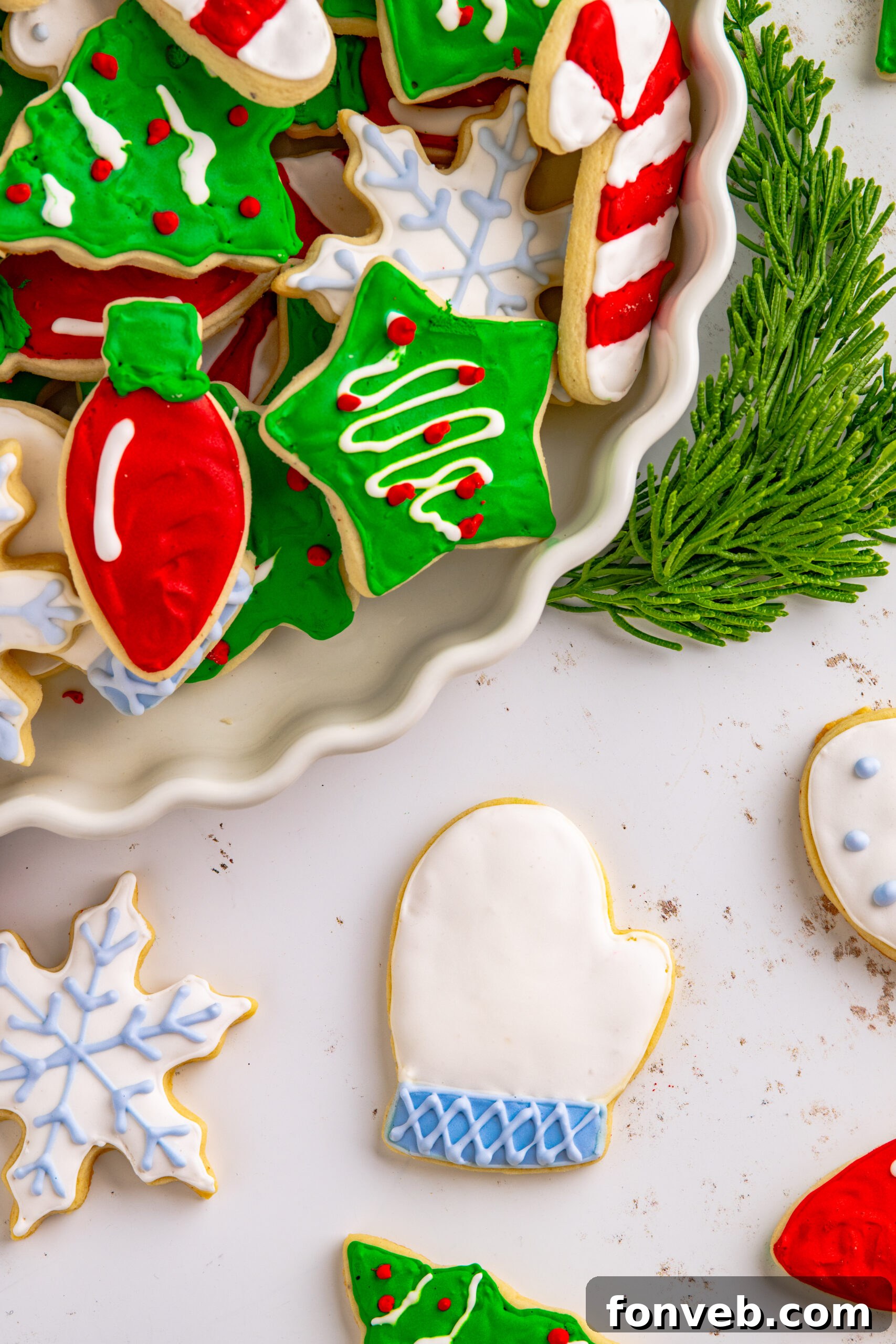 Above shot of a white and light blue Christmas mitten cookie.