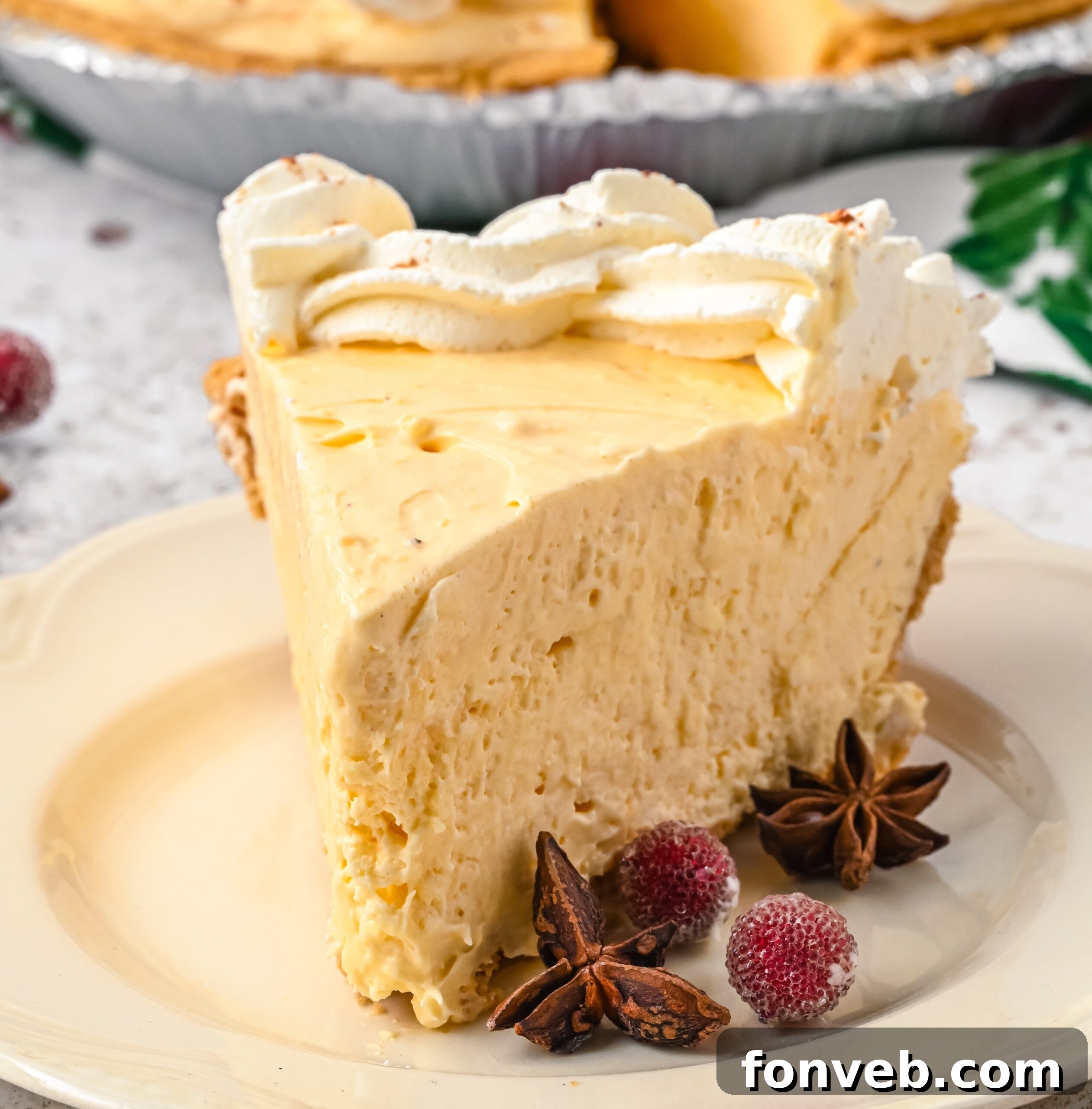 Close up of a slice of eggnog pie on a cream colored plate.
