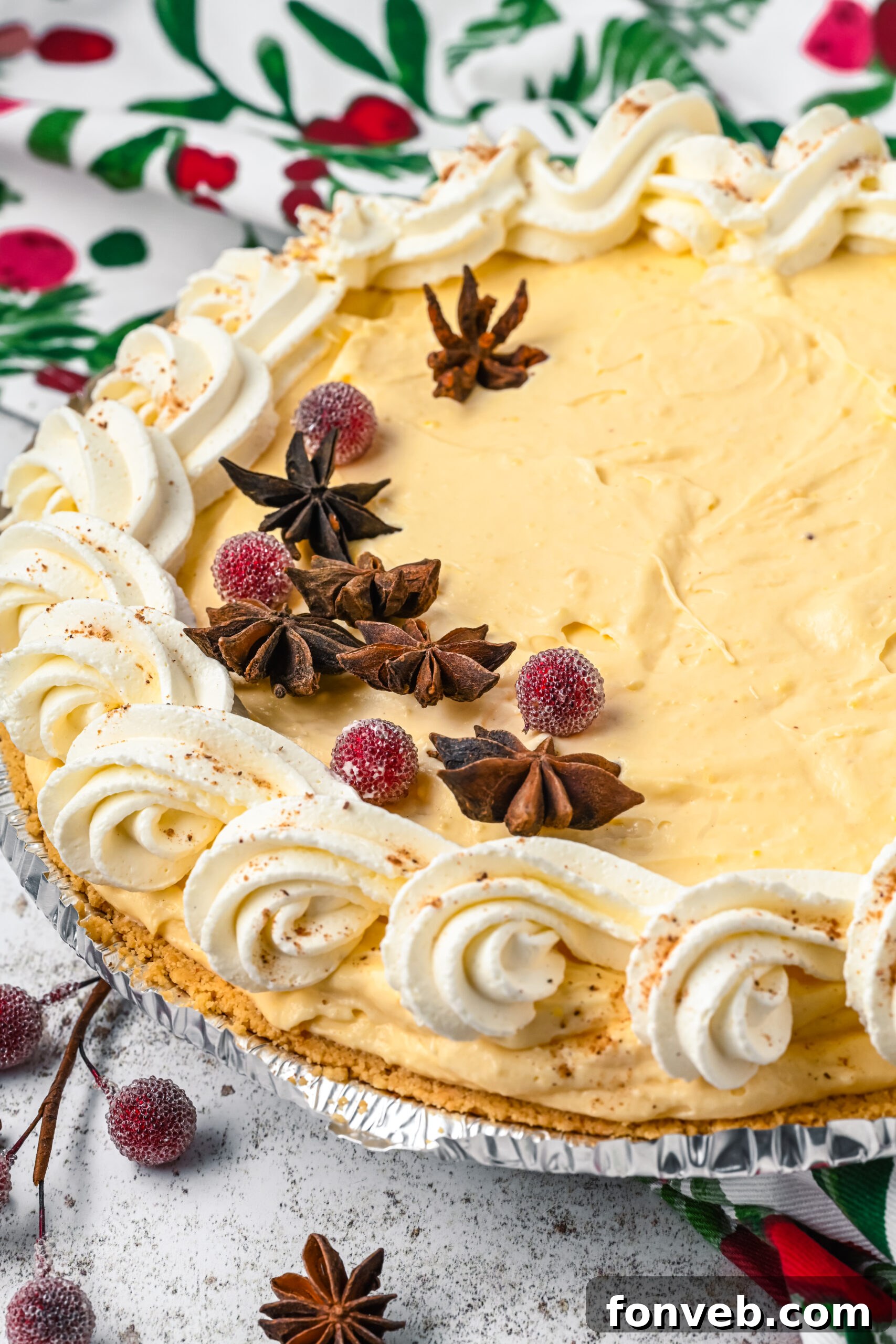45 degree angle of the full decorated Eggnog pie topped with sugared cranberries and star anise. 