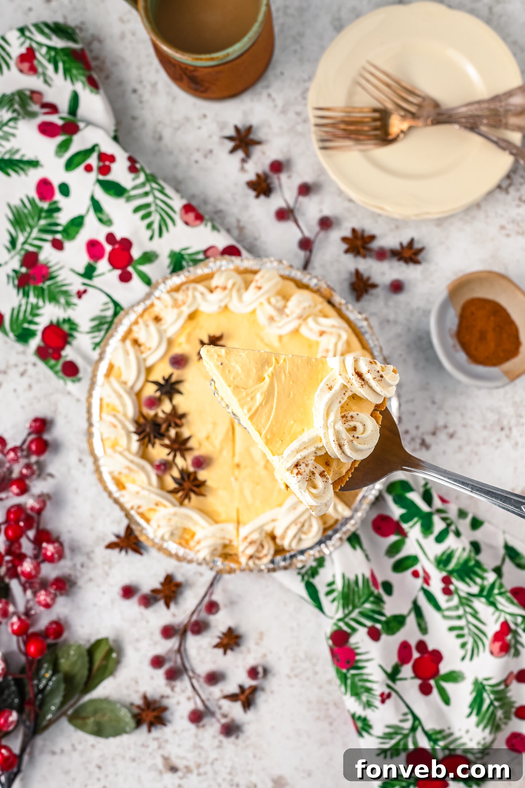 Overhead view of a piece of  pie being removed from the baking dish with a silver spatula. 