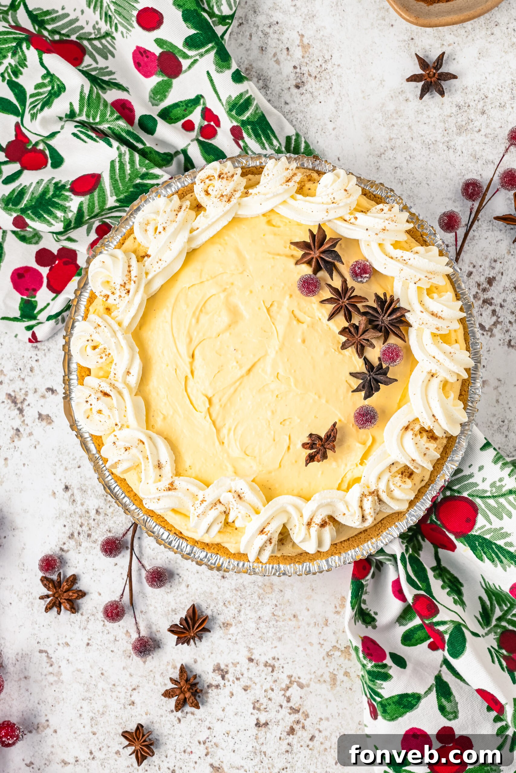 Overhead view of the pie topped with sugared cranberries and star anise. 