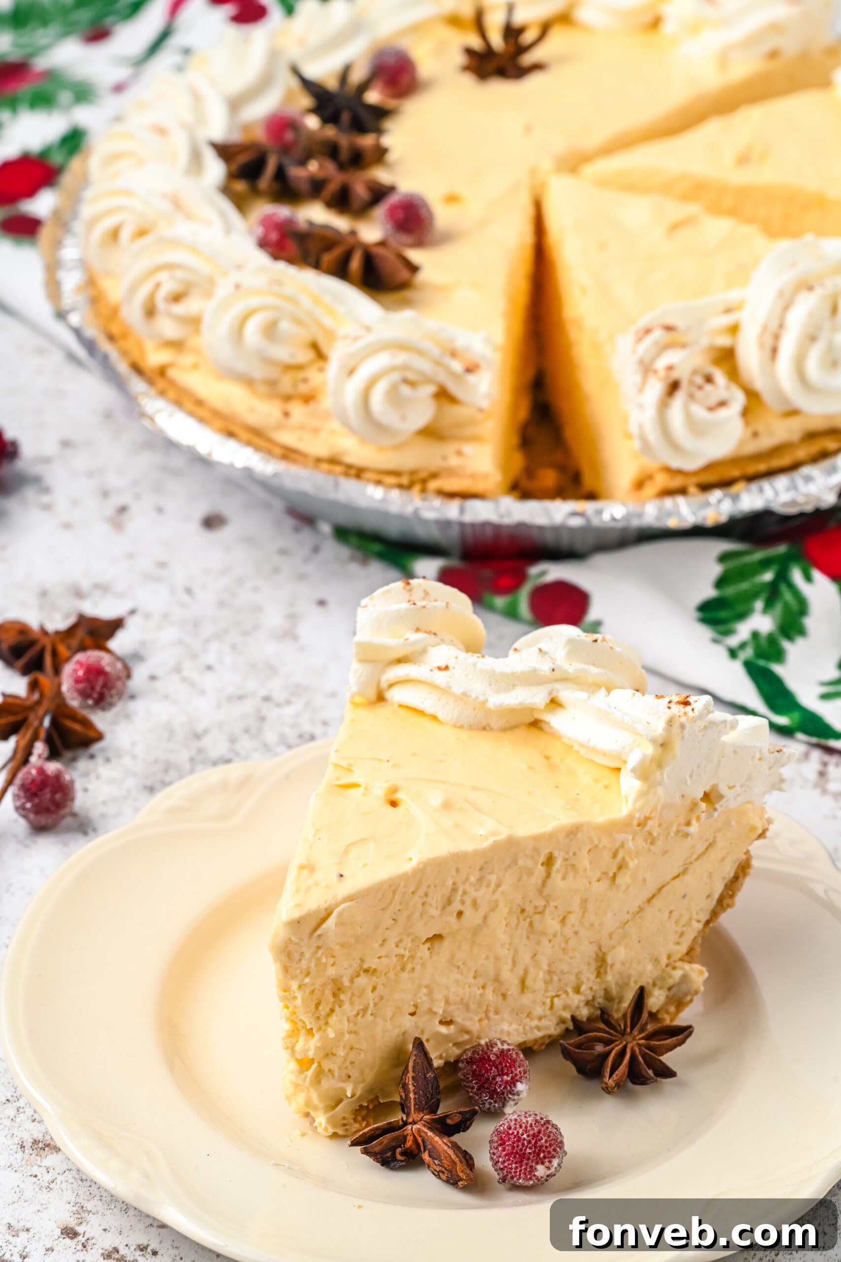 A piece of pie on a white dish with the full pie in the background. 