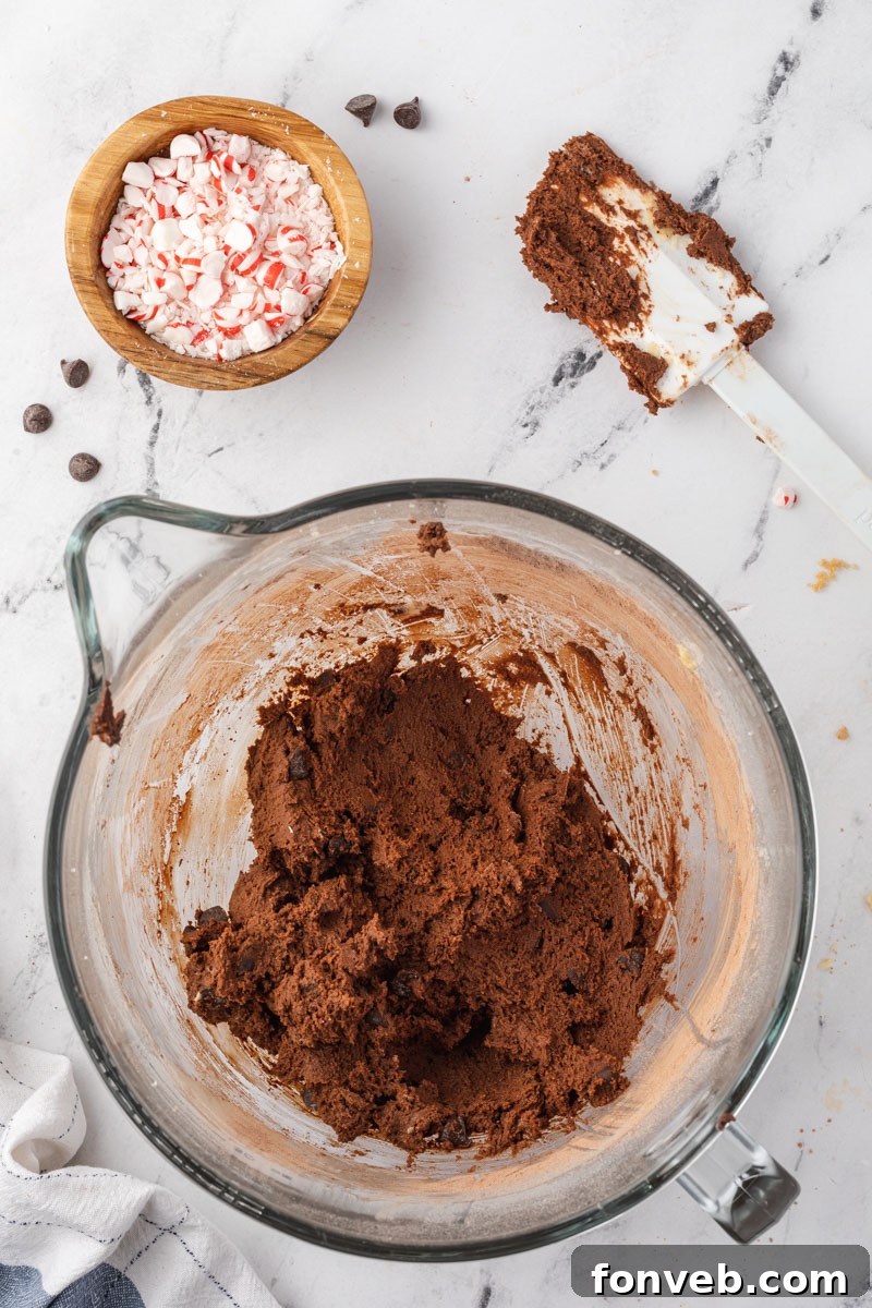 Festive Peppermint Chocolate Delights 4 Overhead shot of the chocolate cookie dough in a mixing bowl, showcasing its rich, dark consistency.