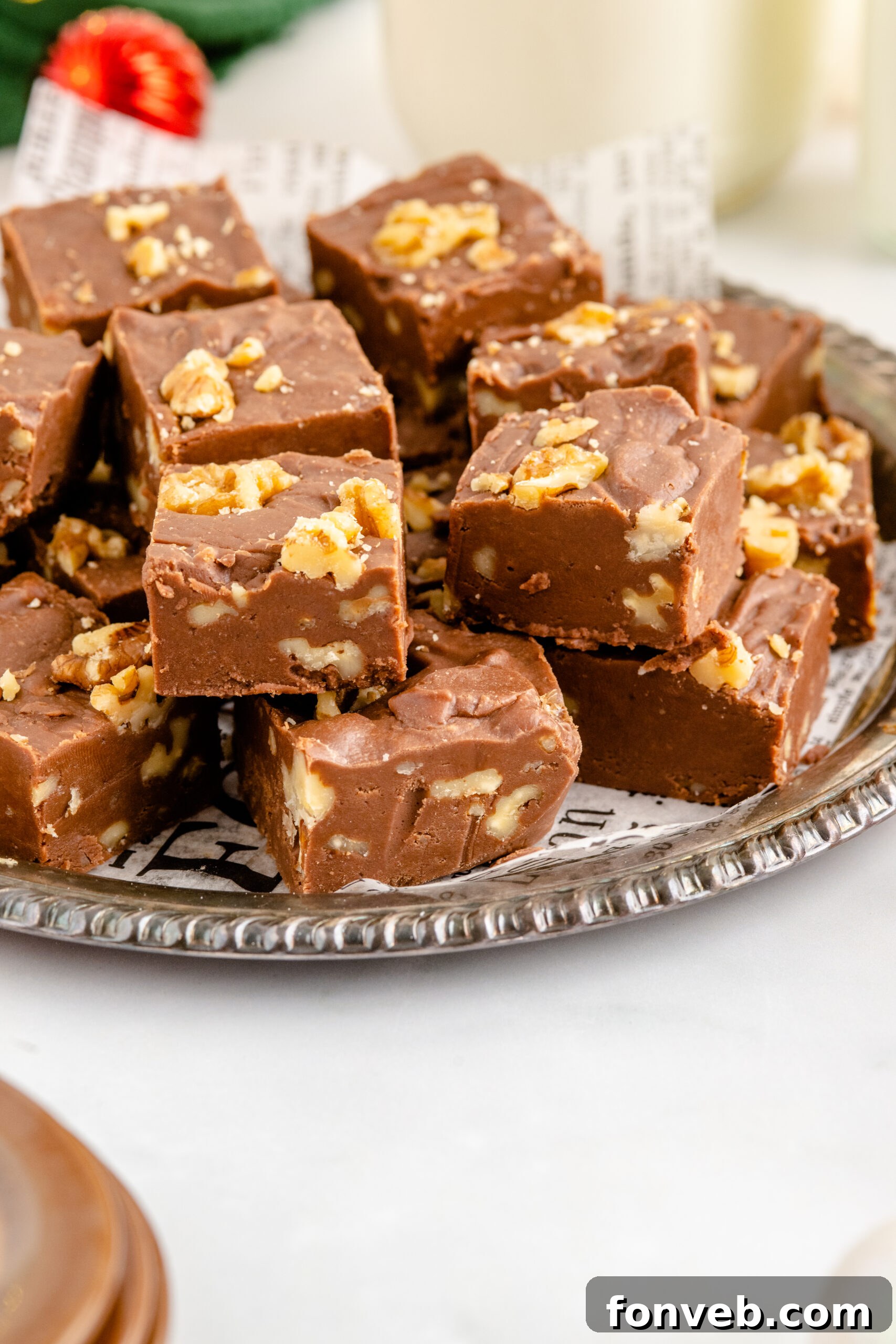 Fantasy Fudge stacked on a tin serving tray with twinkle lights in the background. 