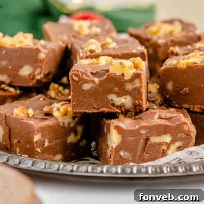 Fantasy Fudge stacked on a tin serving tray with twinkle lights in the background.