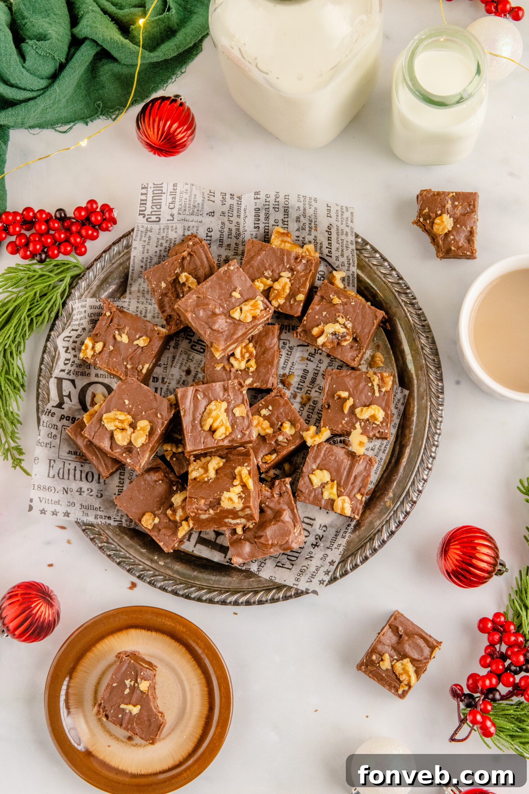 Overhead shot of the fudge stacked on a tin serving tray with holiday decorations in the background. 