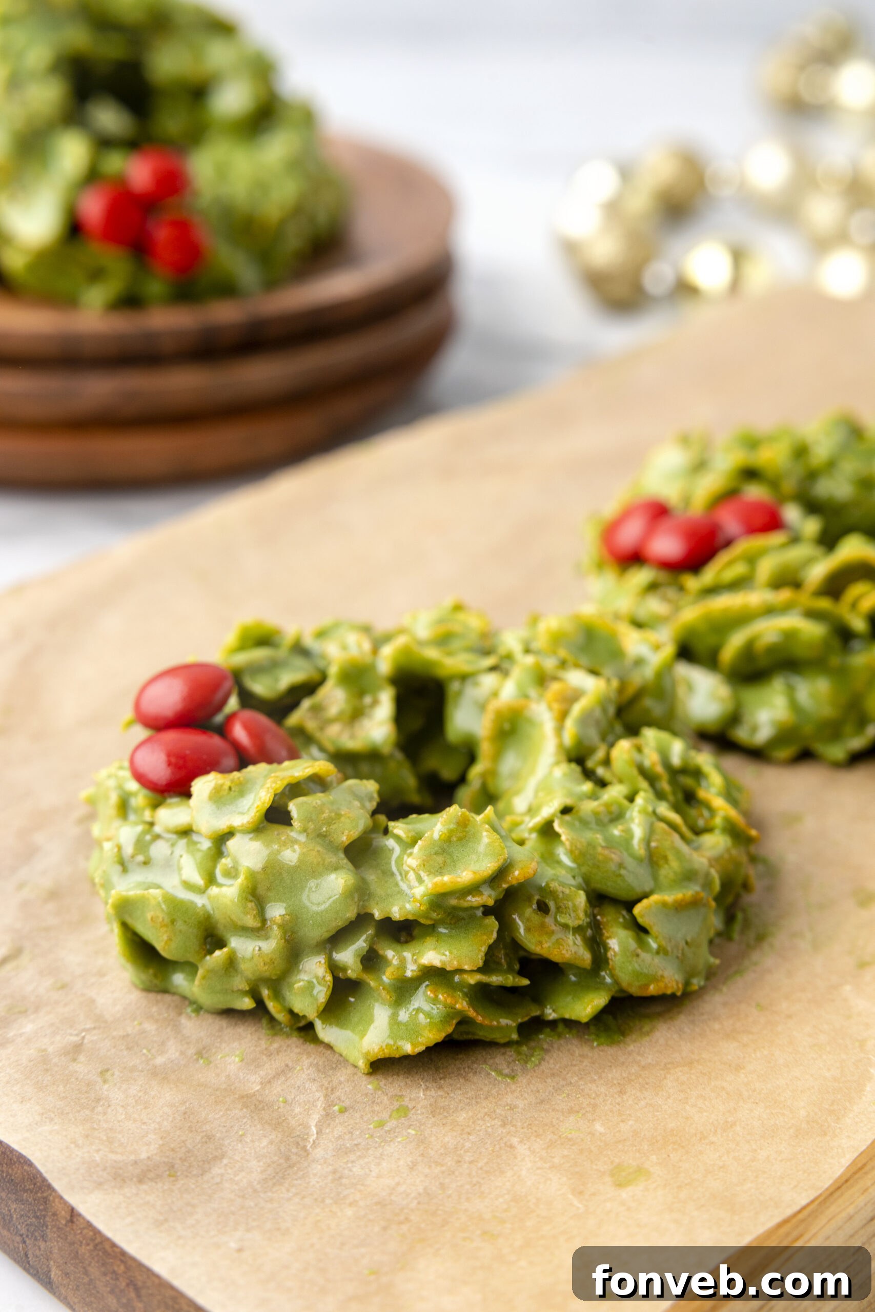 Side view of cornflake wreaths on parchment paper, showcasing their festive shape and vibrant green color.