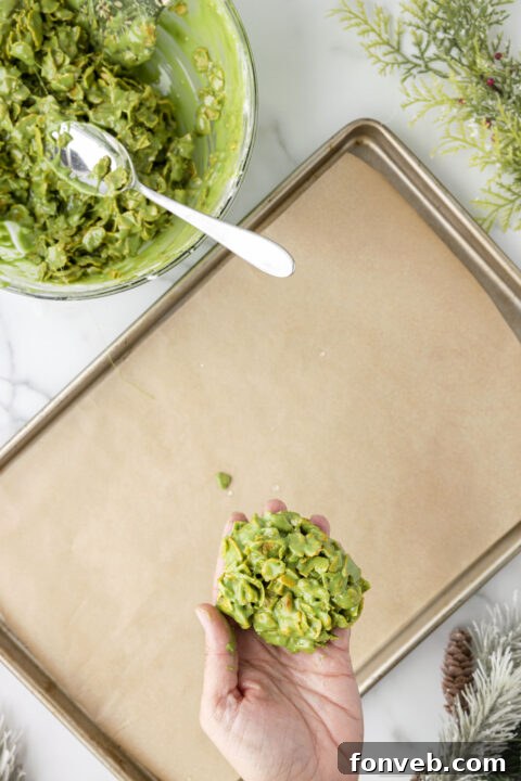 Step-by-step image of shaping the cornflake mixture into a wreath with wet hands.
