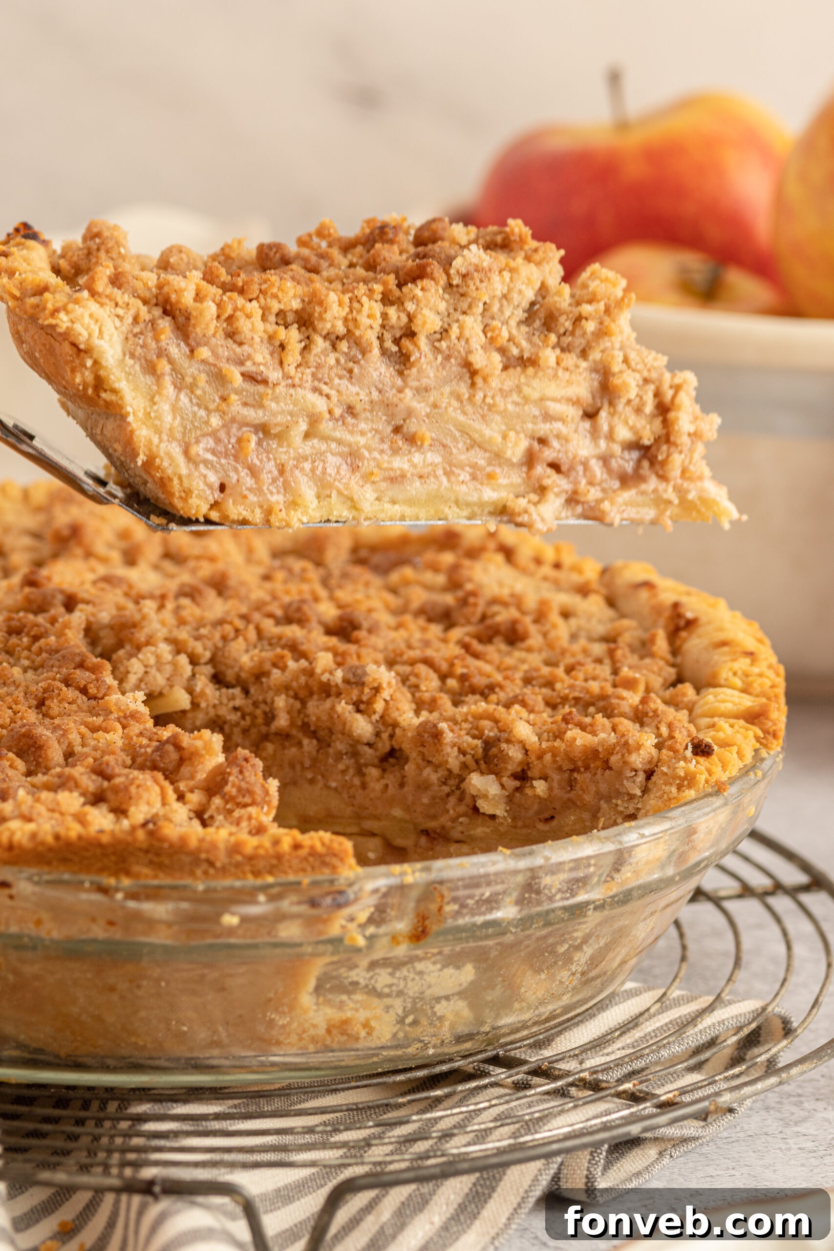 Golden Dutch Apple Crumb Delight 2 Dutch apple Pie slice being lifted on a silver spatula