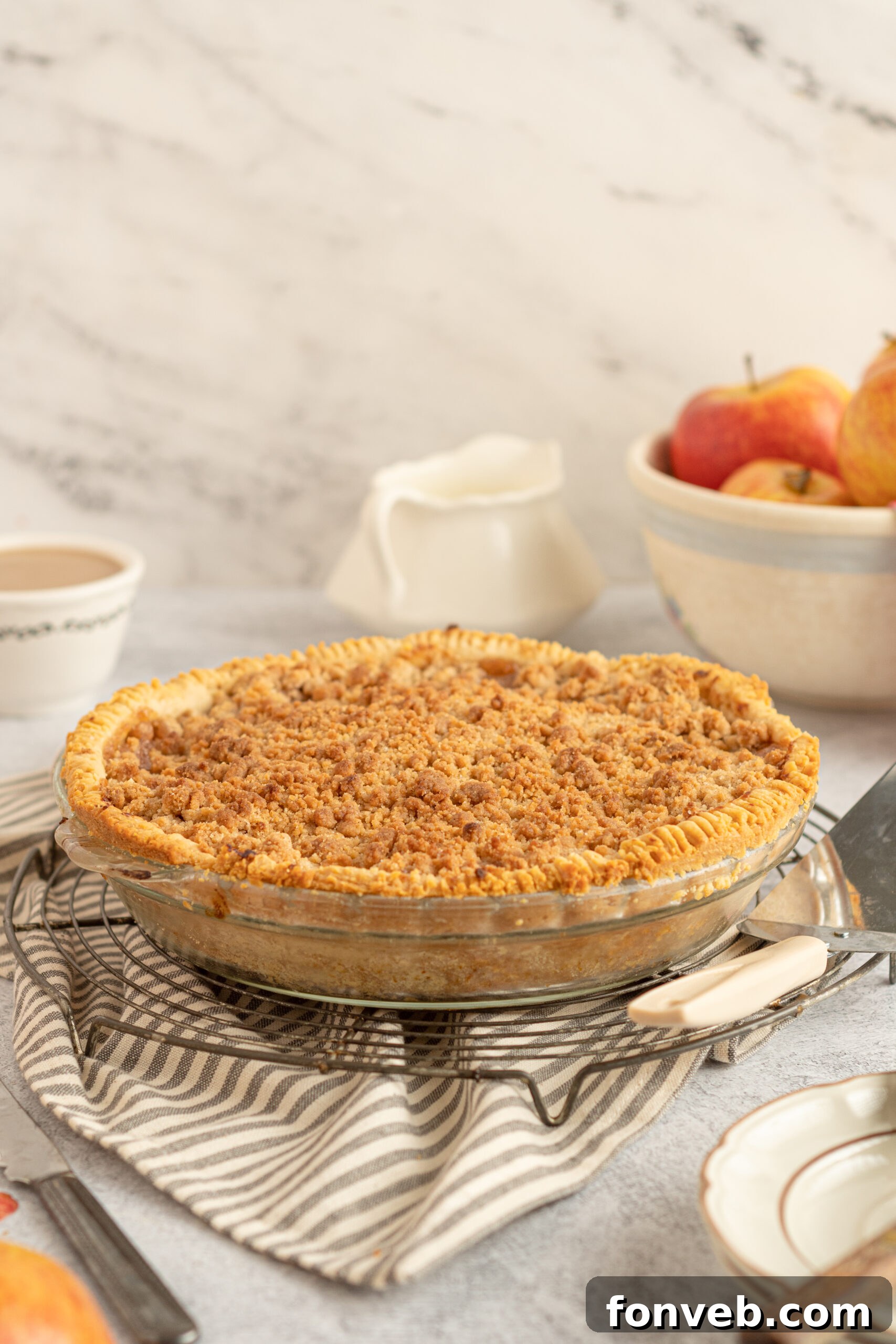 Golden Dutch Apple Crumb Delight 3 Side view of the apple pie on a wire rack.