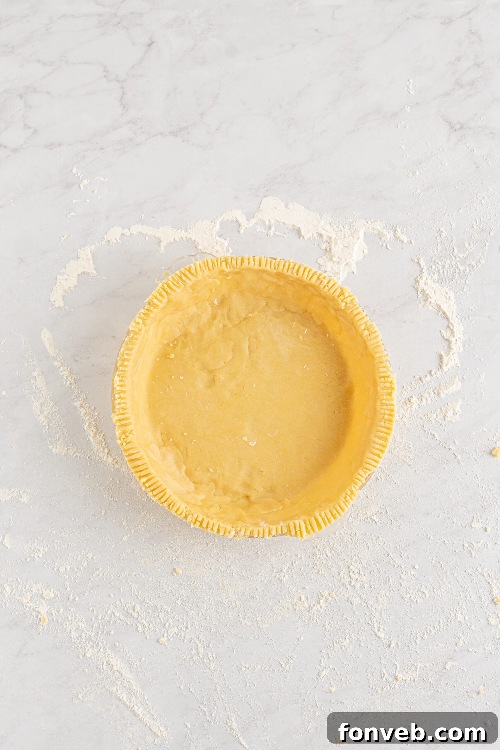 Golden Dutch Apple Crumb Delight 7 Overhead shot of the unbaked crust in the pie dish.