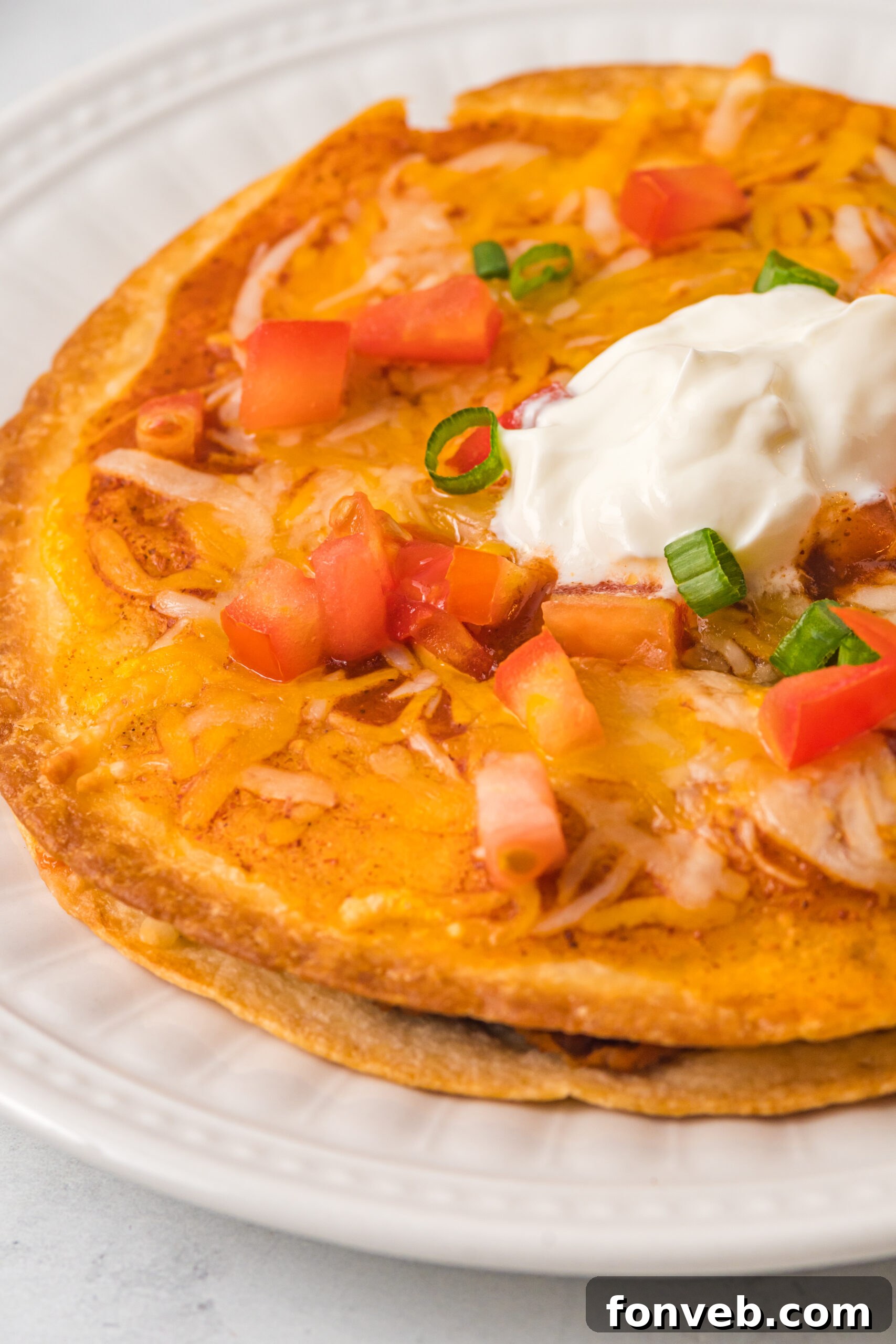 up close shot of a mexican pizza topped with sour cream