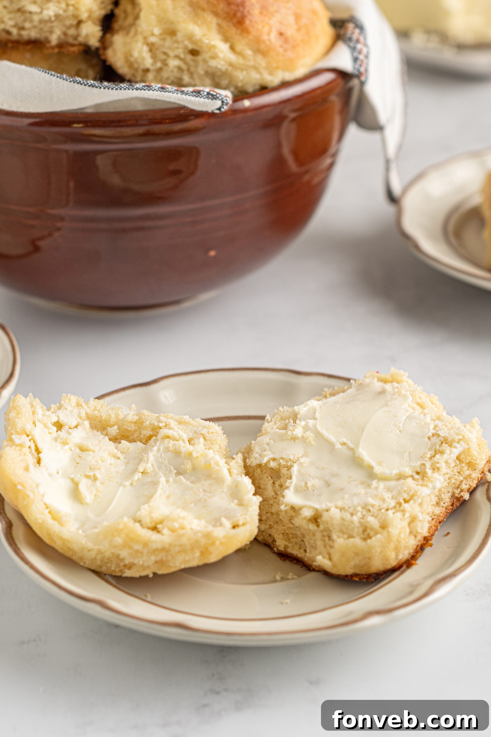 An Angel Biscuit sliced in half, showing its airy, fluffy center, perfectly prepared to absorb toppings like butter or jam.