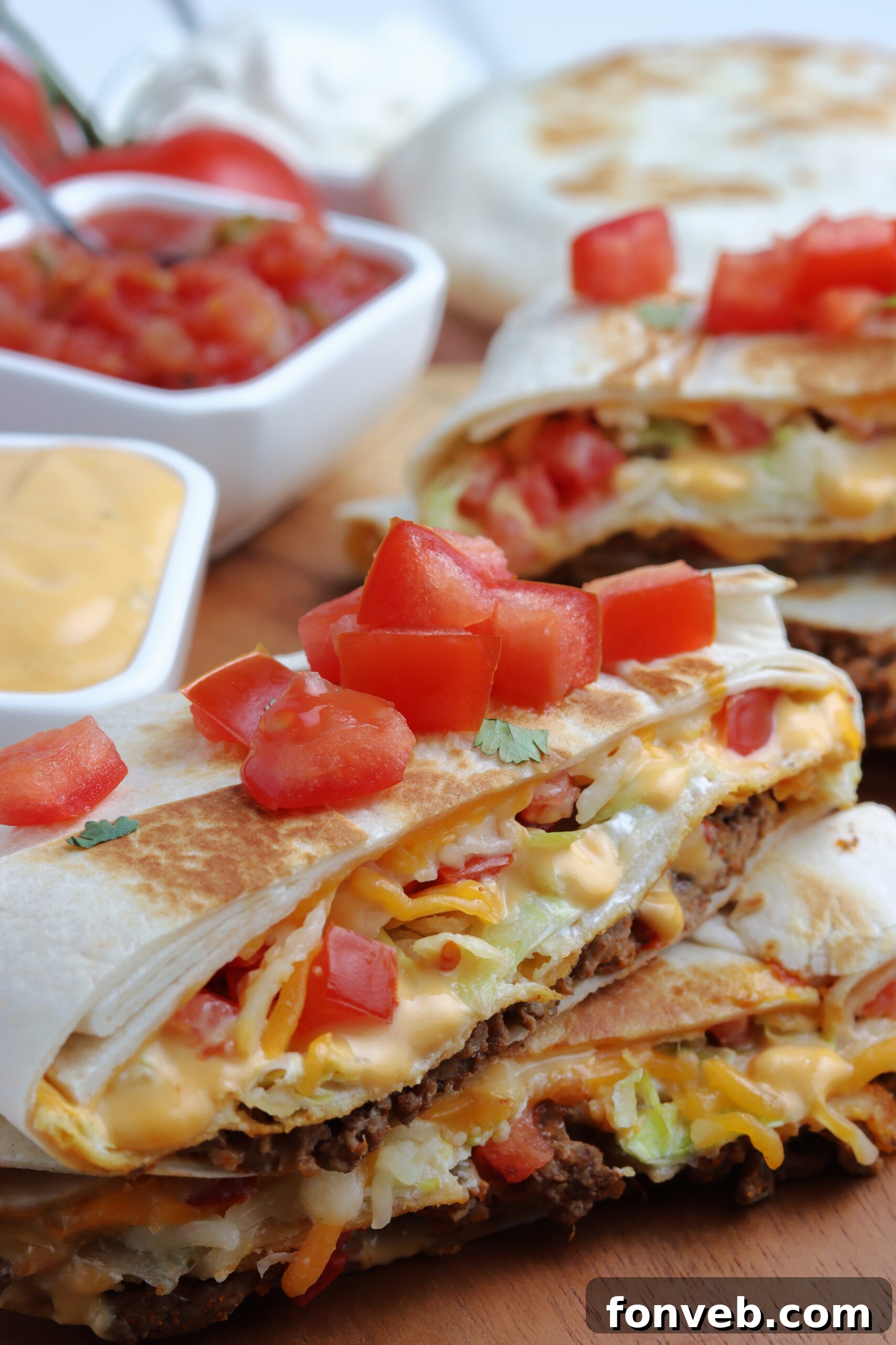 Ultimate Crispy Fold 3 A single crunch wrap cut in half and stacked, displaying its delectable layers.